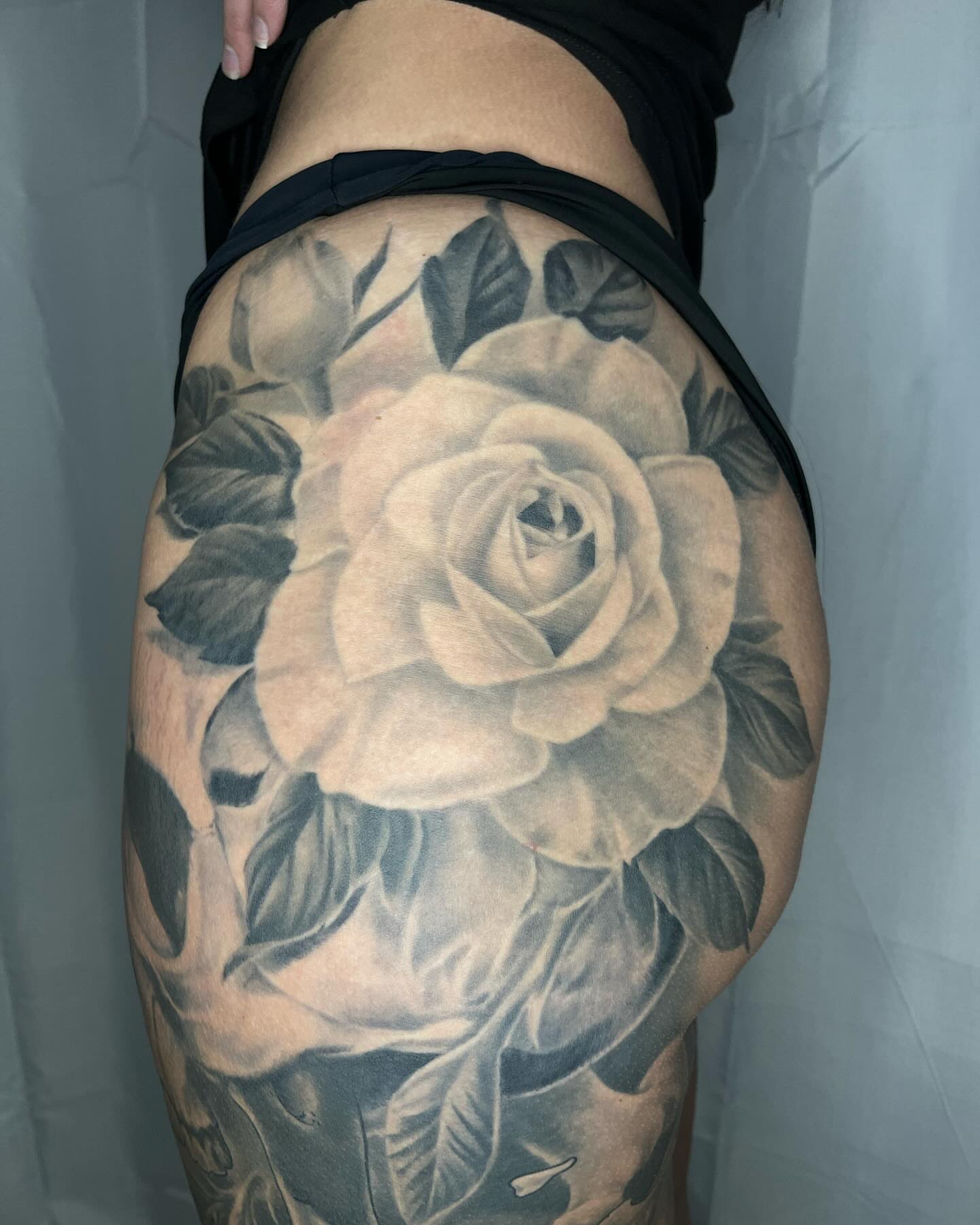 Rose black and grey tattoo on the thigh by biggstattoos