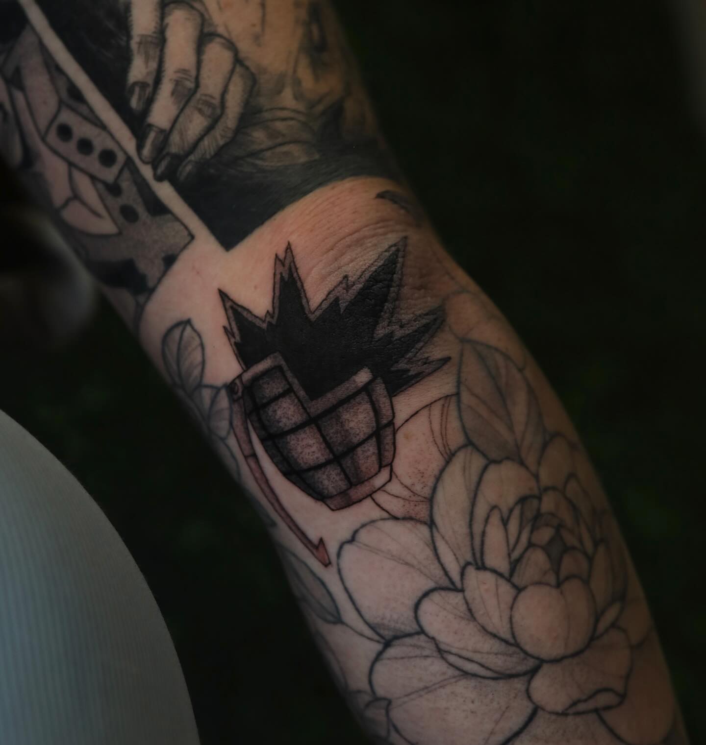 Flower and grenade black and grey tattoo on the forearm by Dana, Phoenix, Arizona