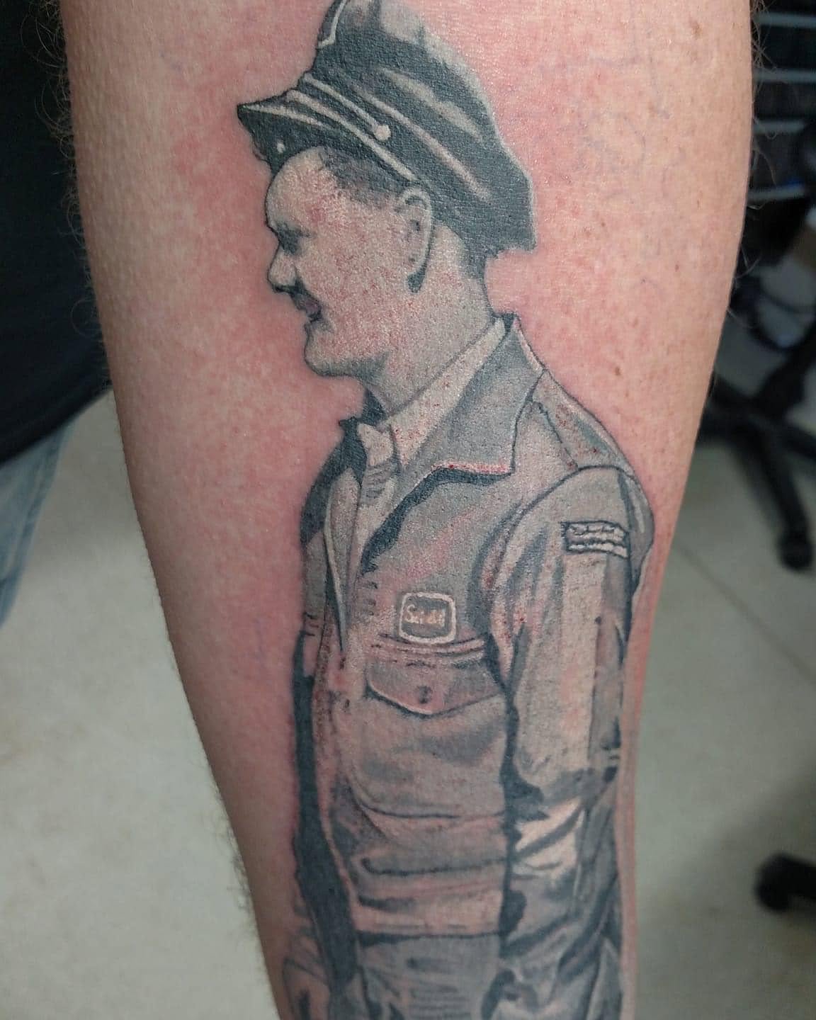 Uniformed soldier realism tattoo on the forearm by Nathan Froehlich