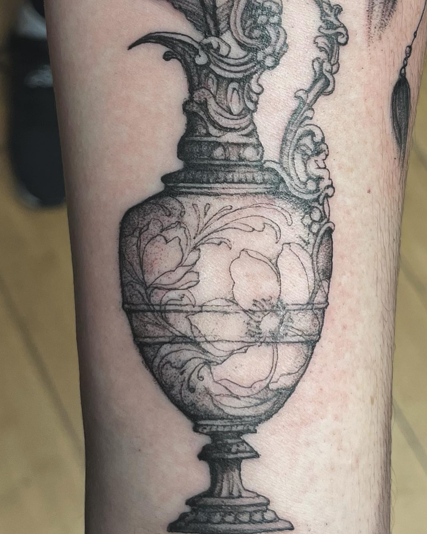 Vase with fruit black and grey tattoo on the forearm by Sarah Spread