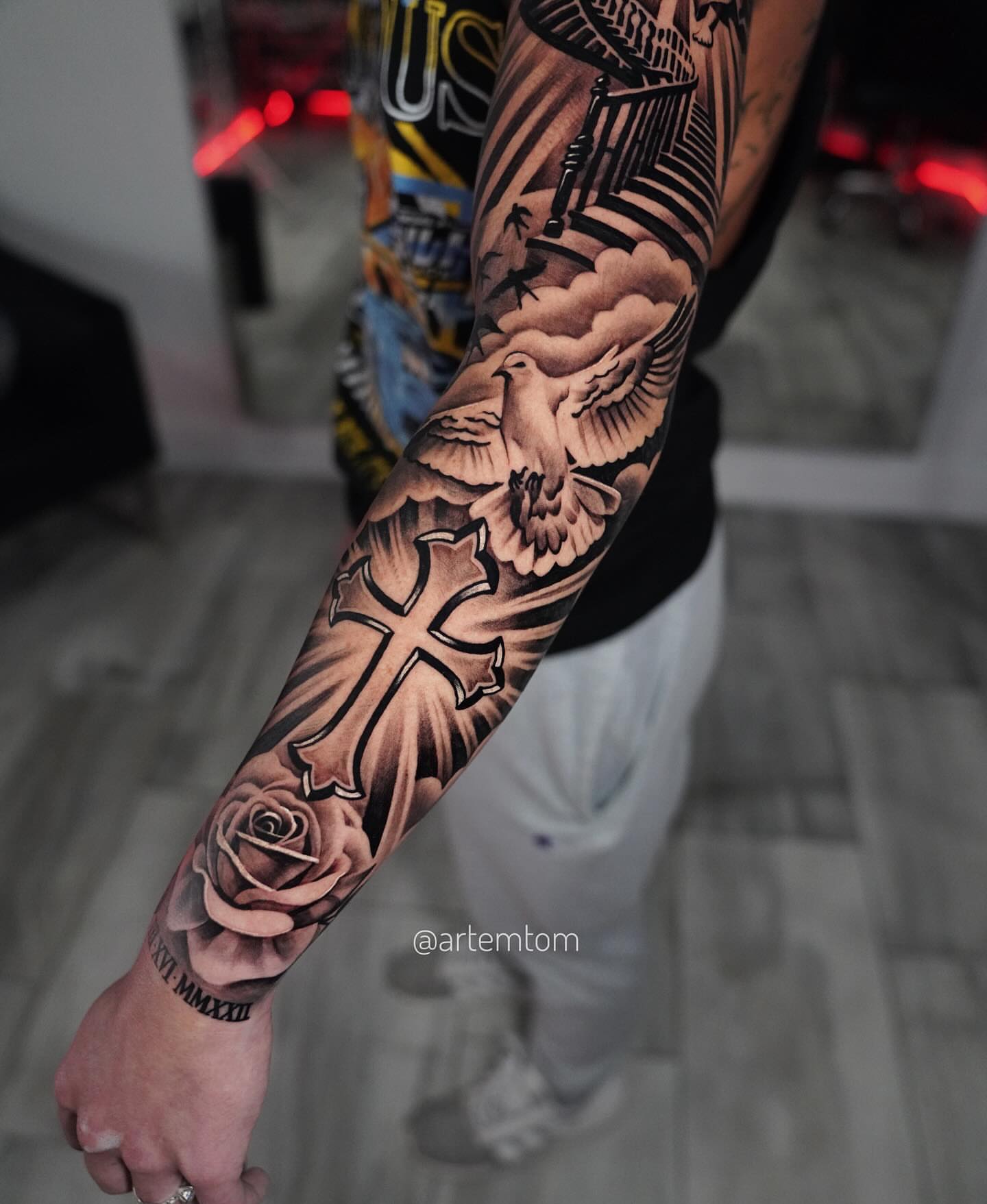 Cross and dove realism tattoo on the forearm by Artem Kunakuzin
