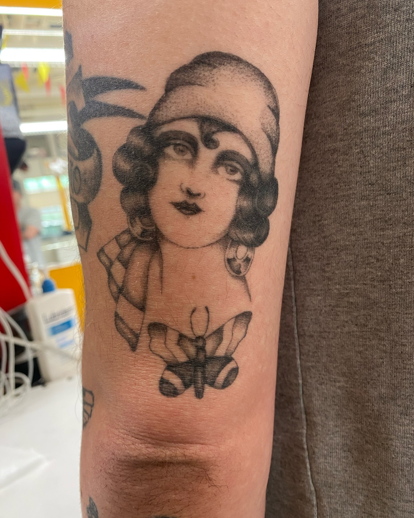 Flapper woman black and grey tattoo on the forearm by Joey Delarosa, San Francisco, California