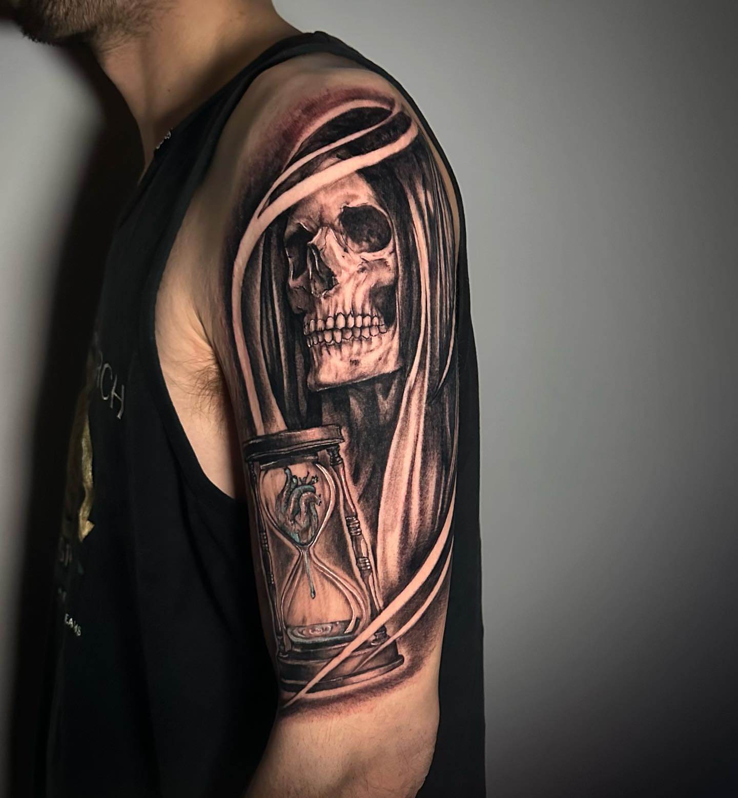 Grim reaper with hourglass realism tattoo on the upper arm by Megan McKee Tattoo Artist