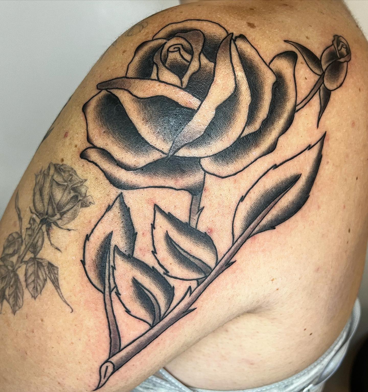 Rose black and grey tattoo on the shoulder by Pedroux M.