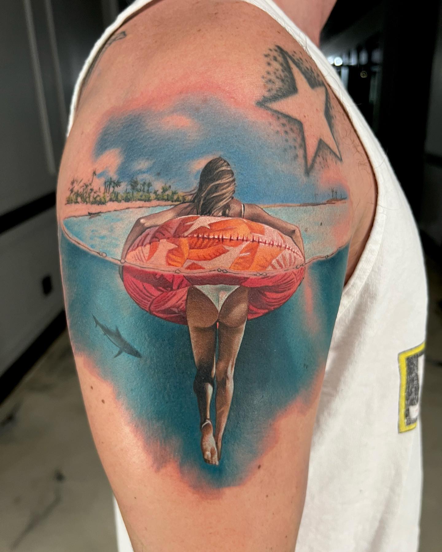 Beach scene realism tattoo on the shoulder by Derek Gardner