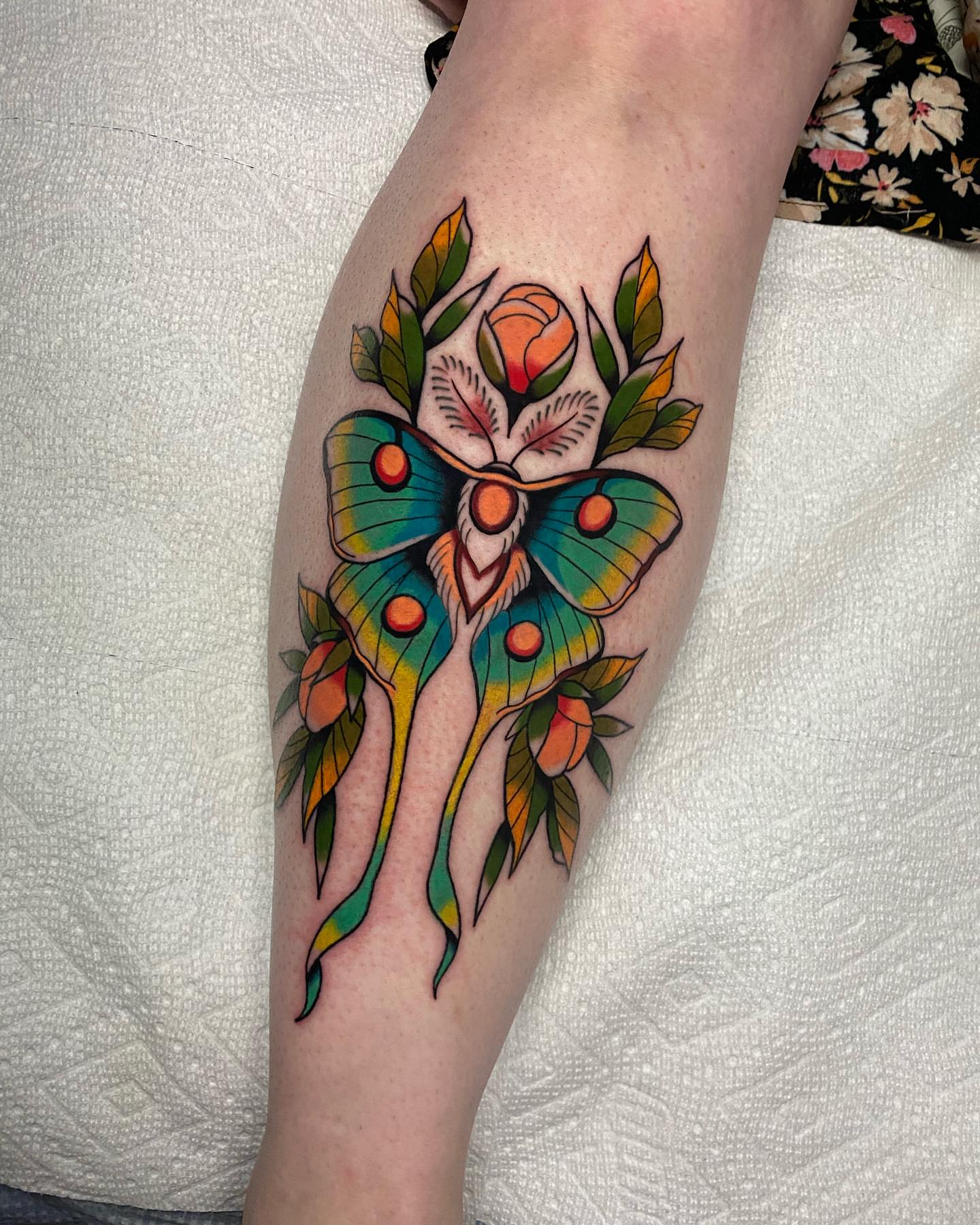 Butterfly and flowers American traditional tattoo on the forearm by Mitch Hoggard
