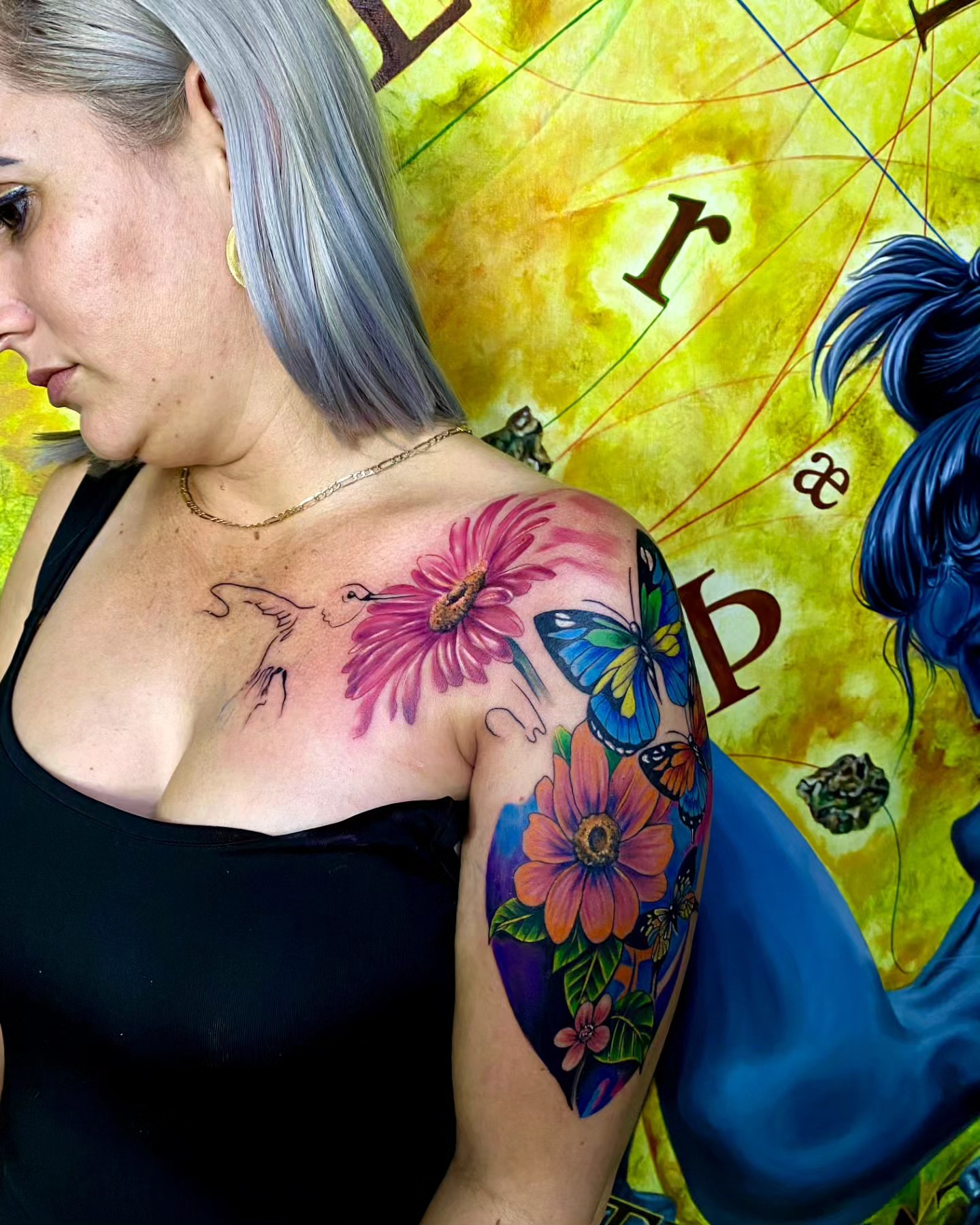 Flower and butterfly new school tattoo on the shoulder by Gabriel Garcia