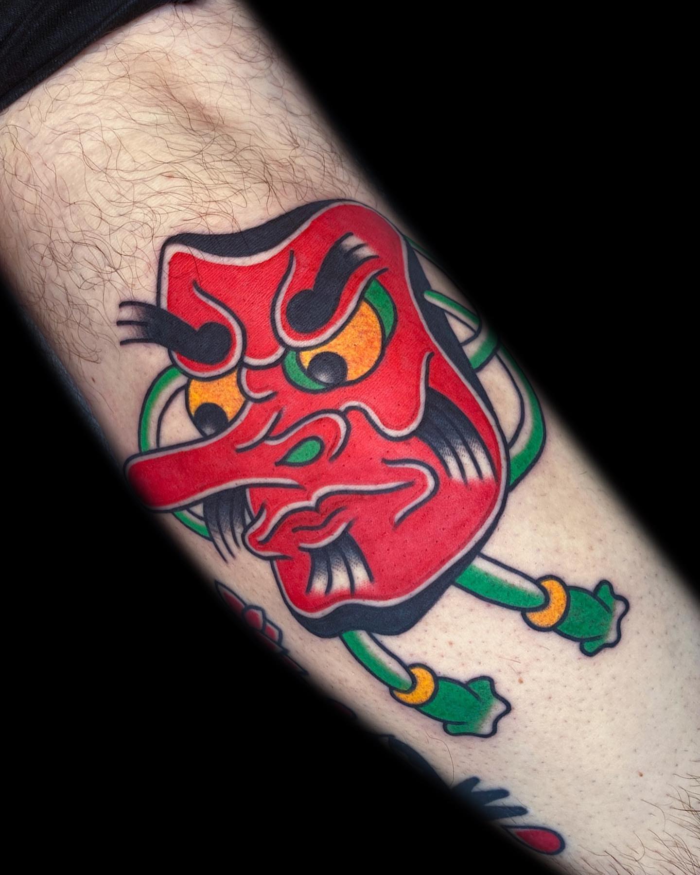 Demon mask American traditional tattoo on the forearm by The Calamari Kid