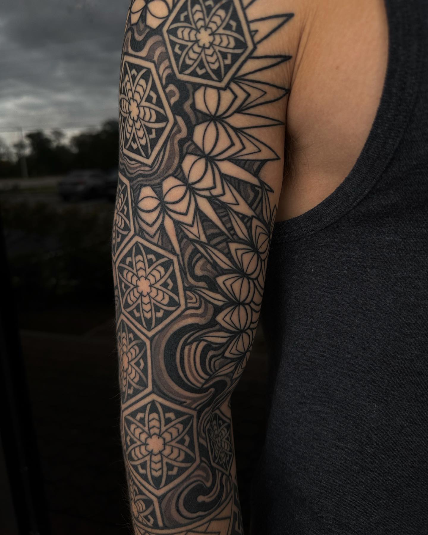 Geometric floral pattern geometric tattoo on the upper arm by Ryan K Severe