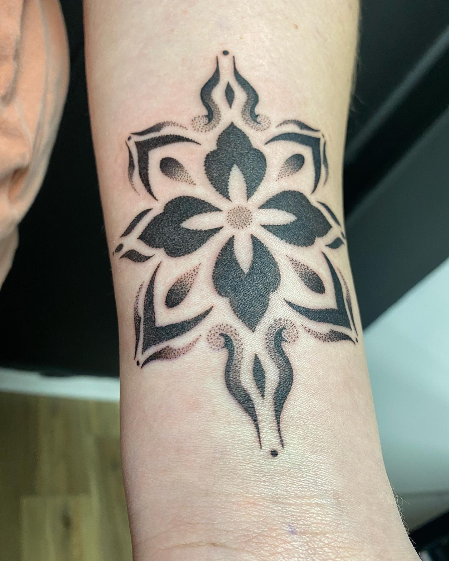Floral design dotwork tattoo on the forearm by Rose Ulinski