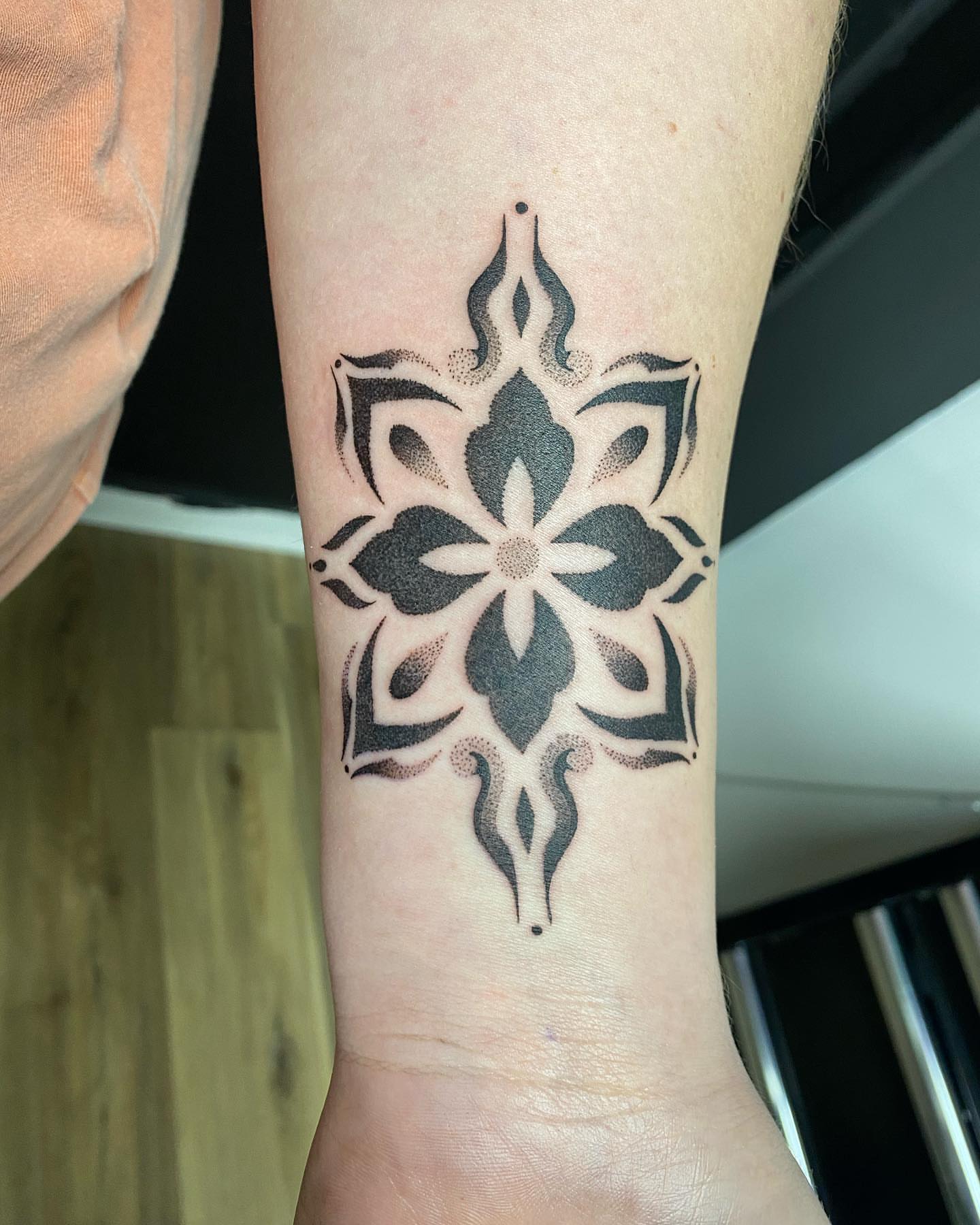 Geometric mandala dotwork tattoo on the forearm by Rose Ulinski