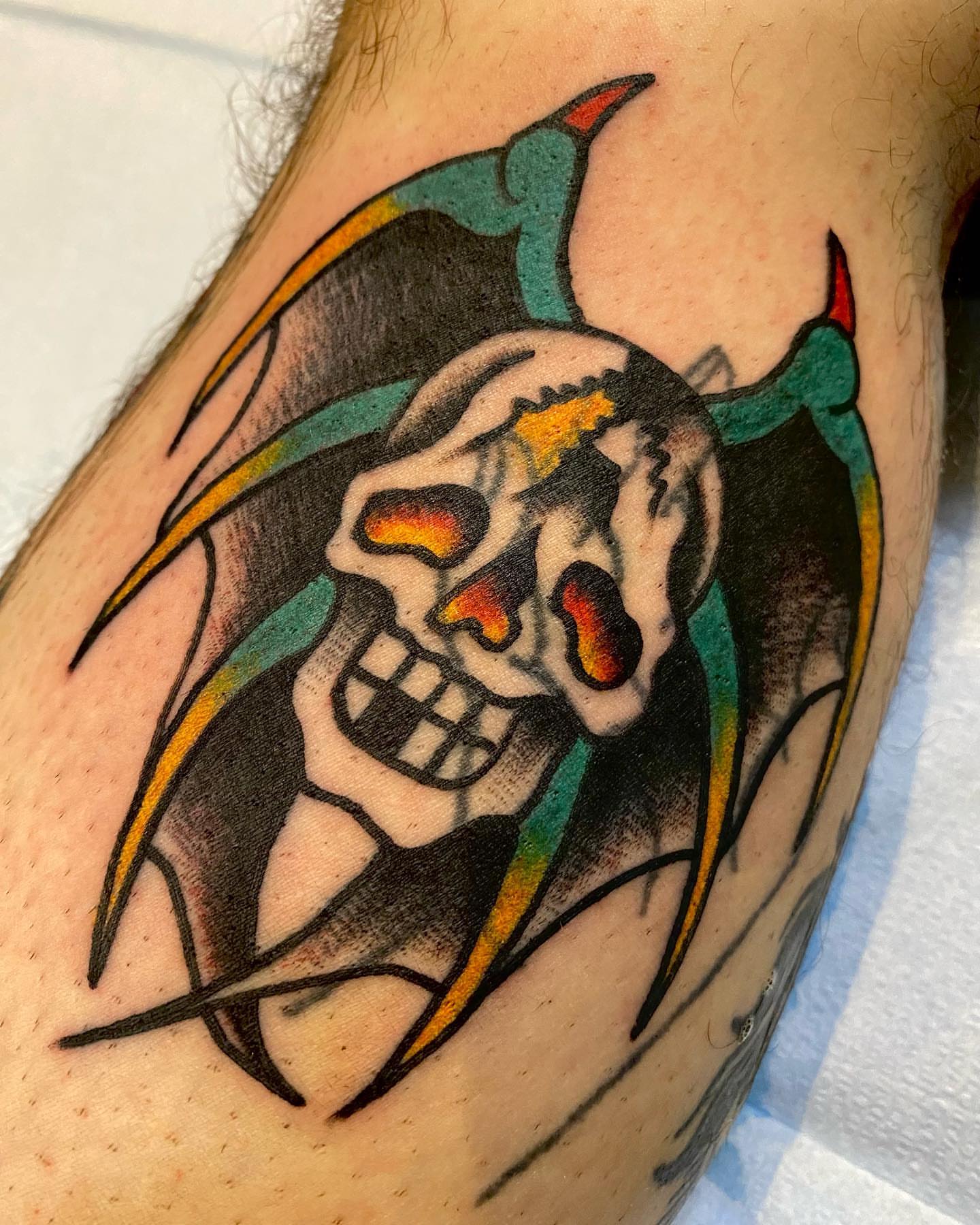 Skull American traditional tattoo on the forearm by Dorian Grey Baker
