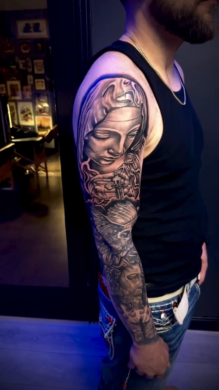 Woman's face and religious imagery realism tattoo by Paul burrows (Tatttoo Artist)
