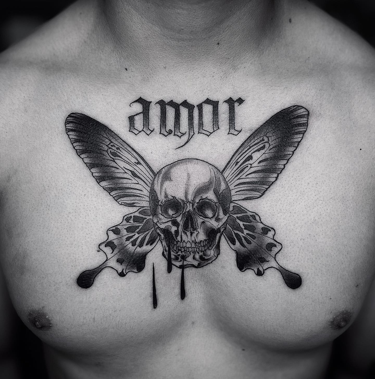 Skull with butterfly wings realism tattoo on the chest by Lorenzo Gomez, San Diego, California