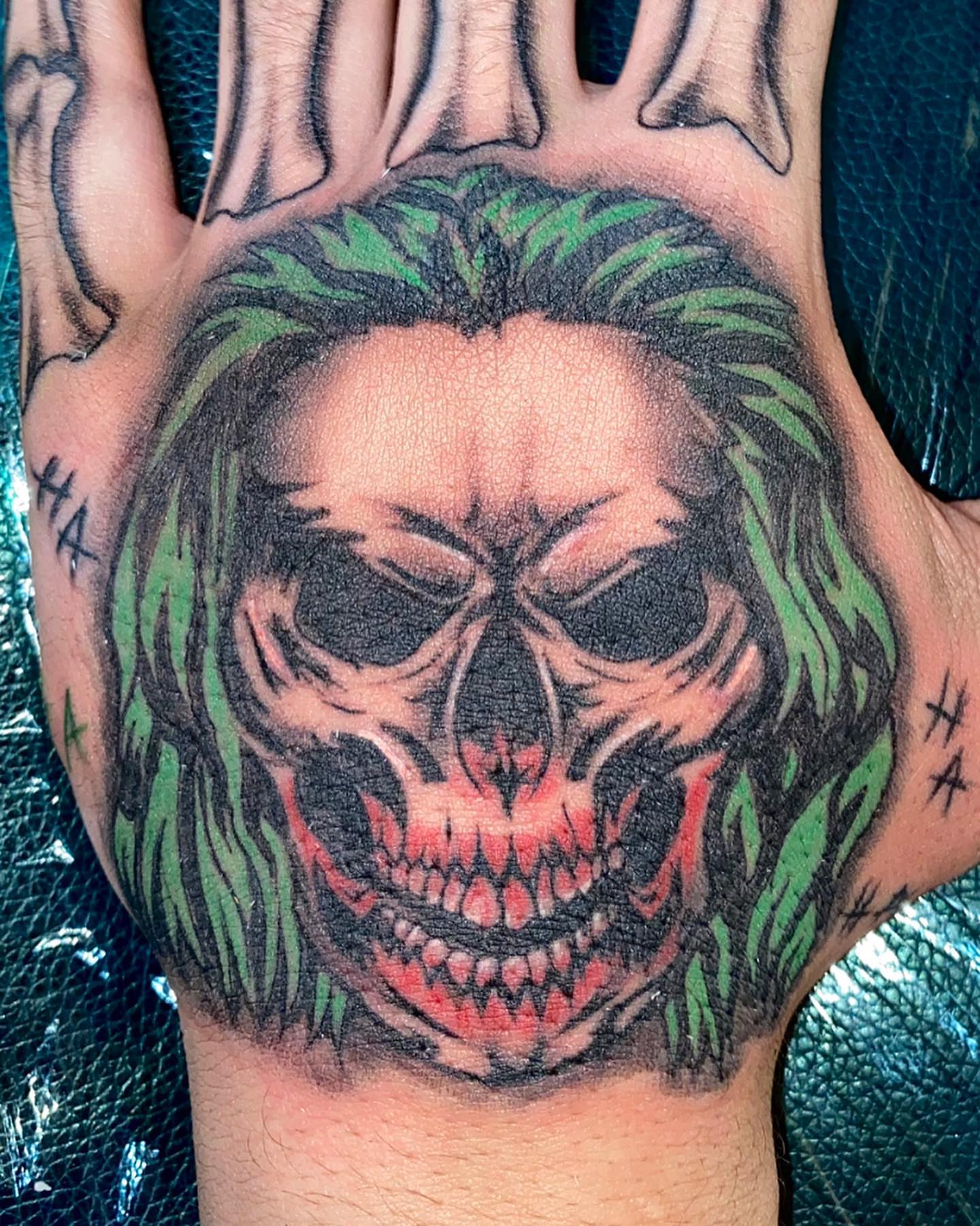 Joker skull dark realism tattoo on the hand by ππππππ