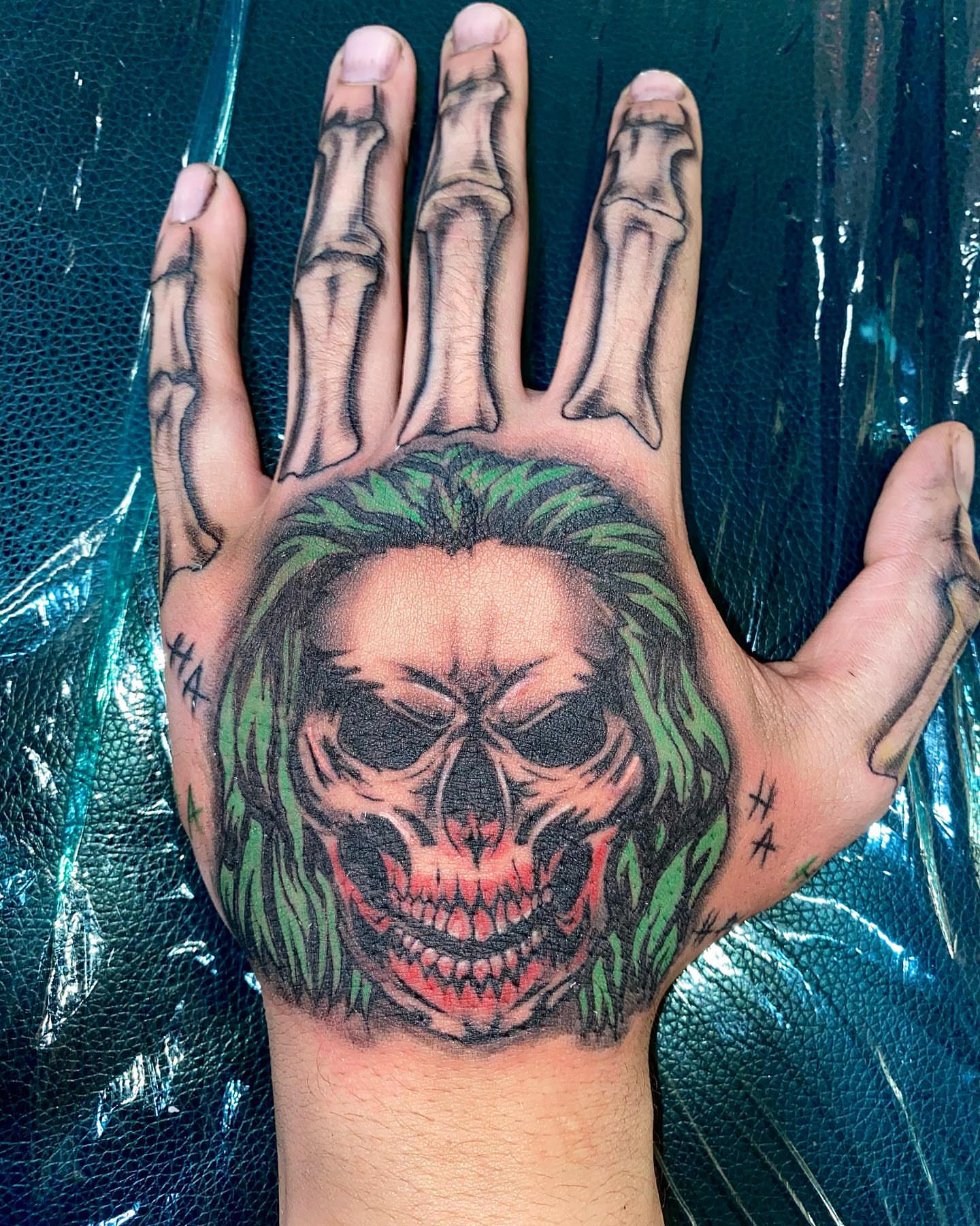 Joker skull dark realism tattoo on the hand by ππππππ