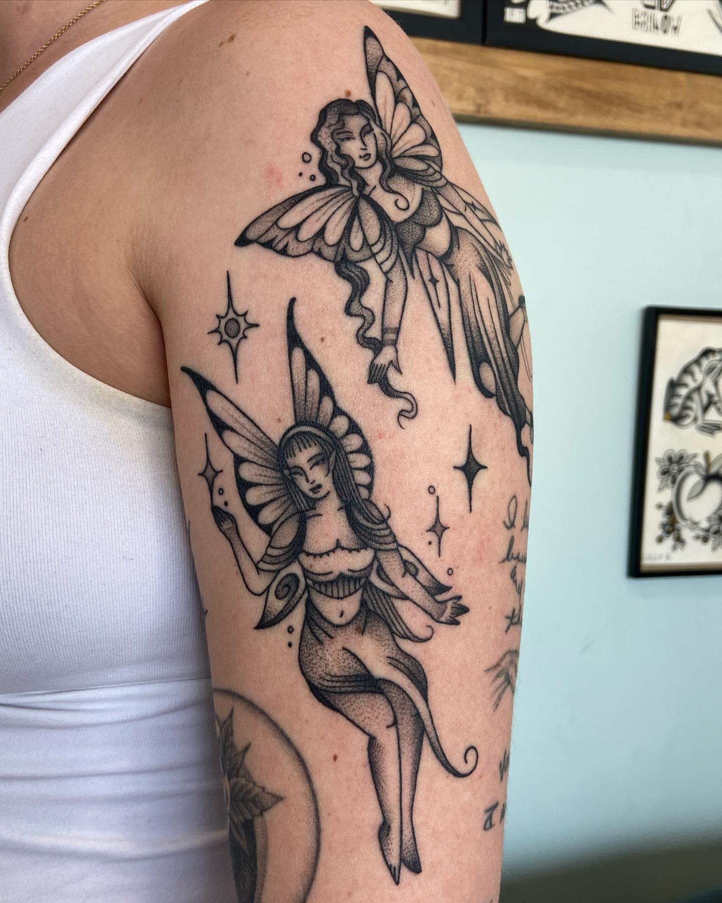 Fairies dotwork tattoo on the upper arm by Lilly Binns