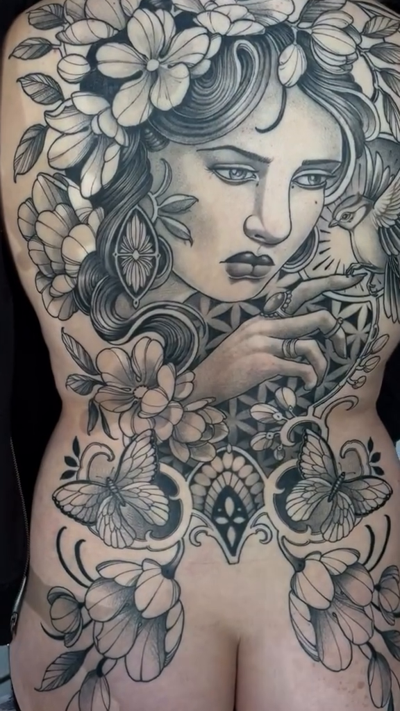Woman with flowers and skull realism tattoo by Madelyn Roberts, Bellingham, Washington