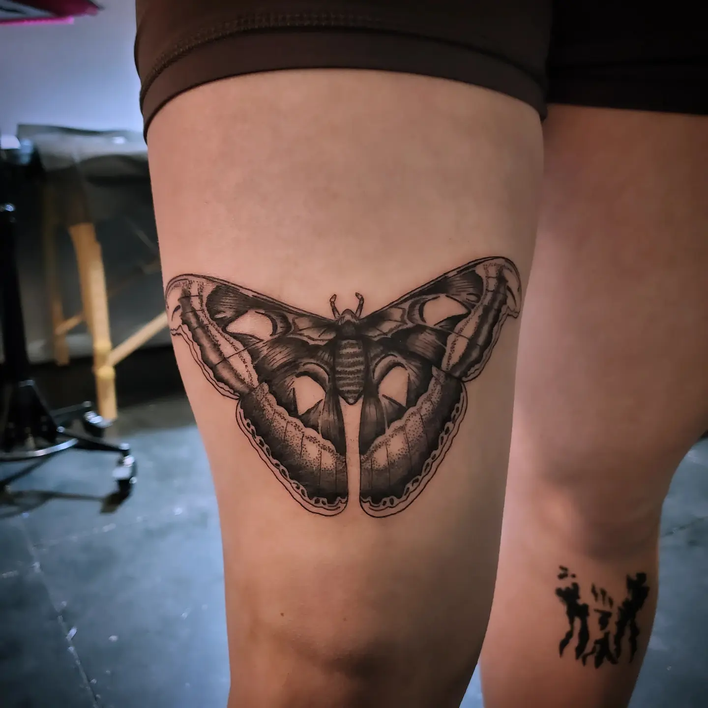 Butterfly black and grey tattoo on the thigh by Shailey Pasquale