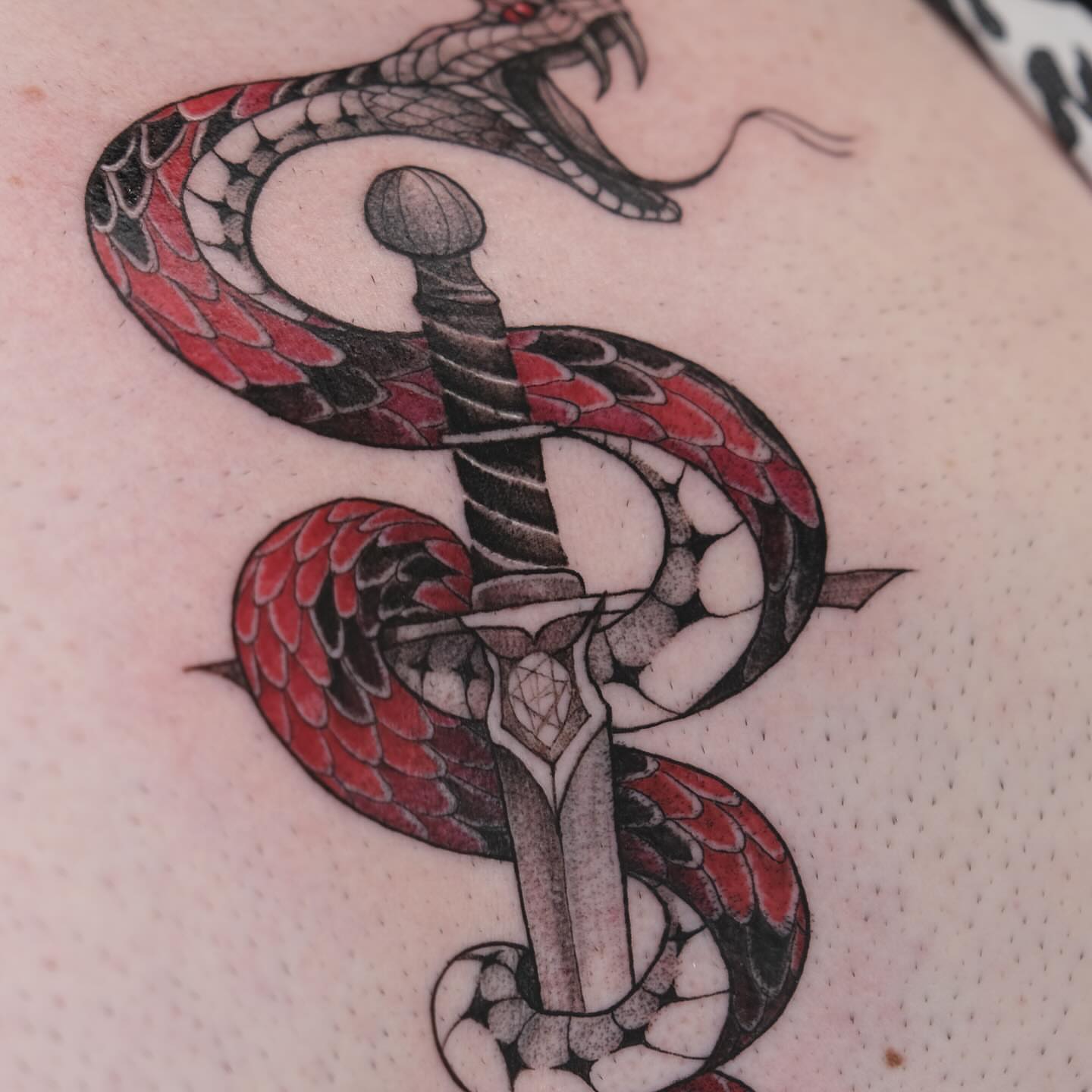 Snake and dagger American traditional tattoo on the shoulder by Ka hiu chiu
