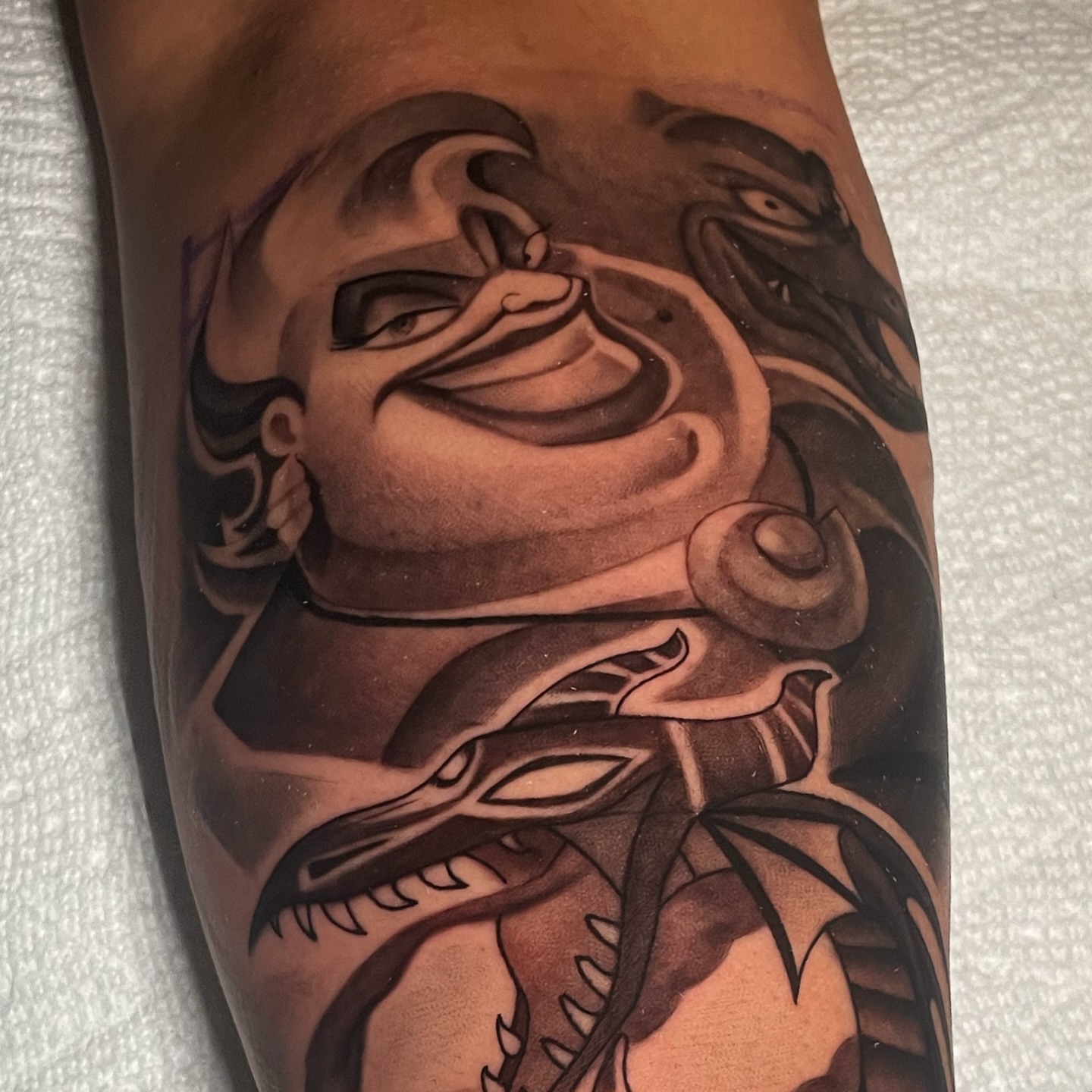 Woman with snake realism tattoo on the forearm by Geo