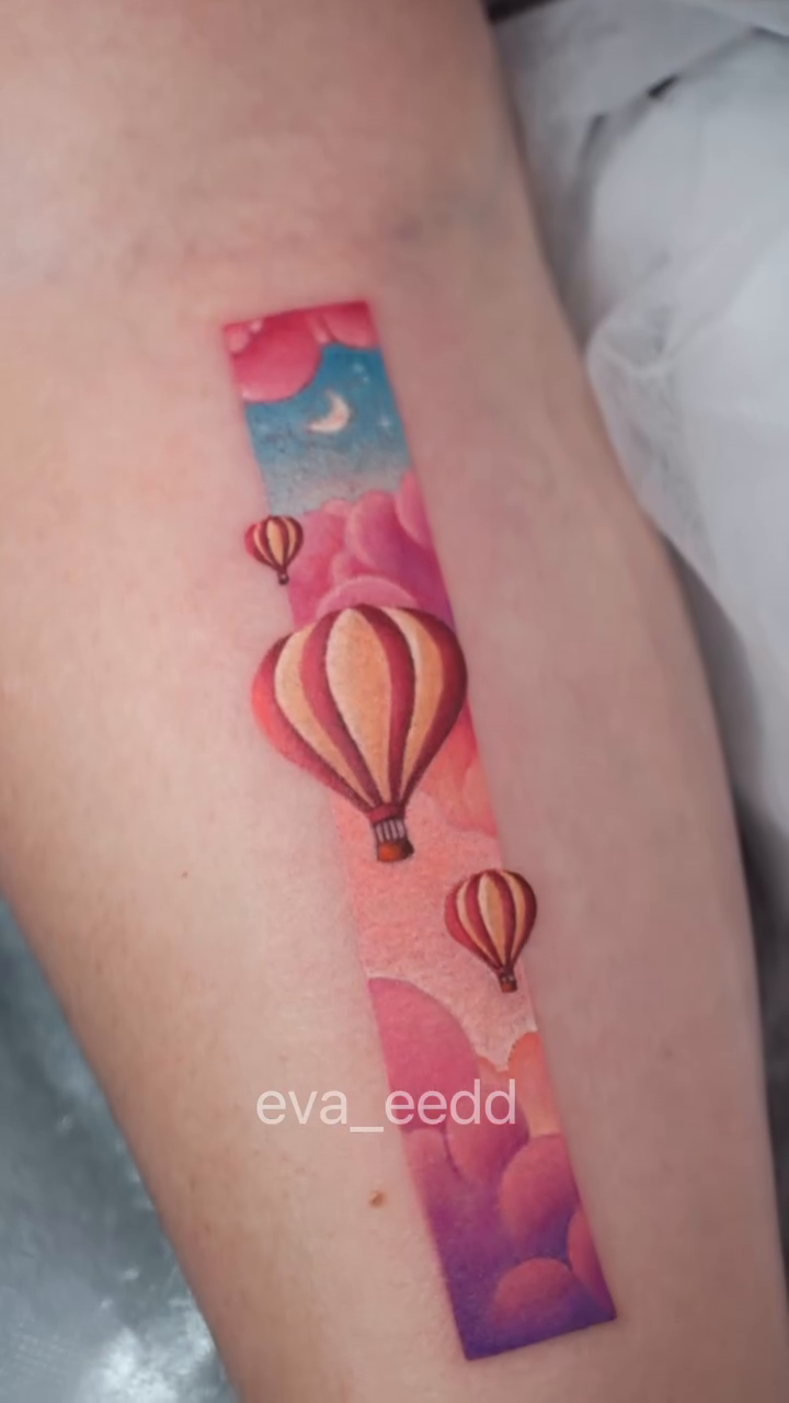 Hot air balloons in a sky watercolor tattoo by Eva Liu