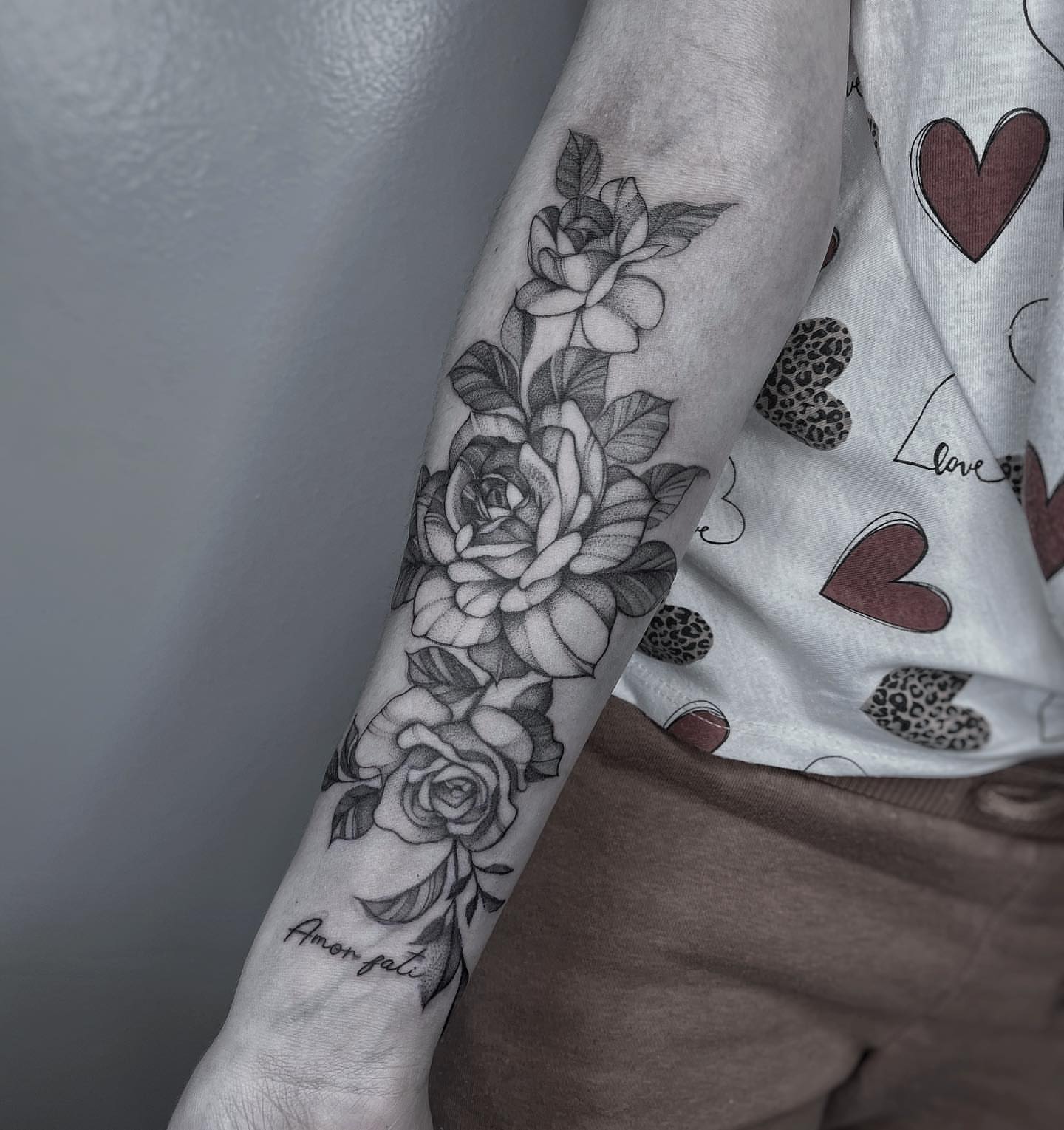 Roses black and grey tattoo on the forearm by Tattoo Yulia Kononenko