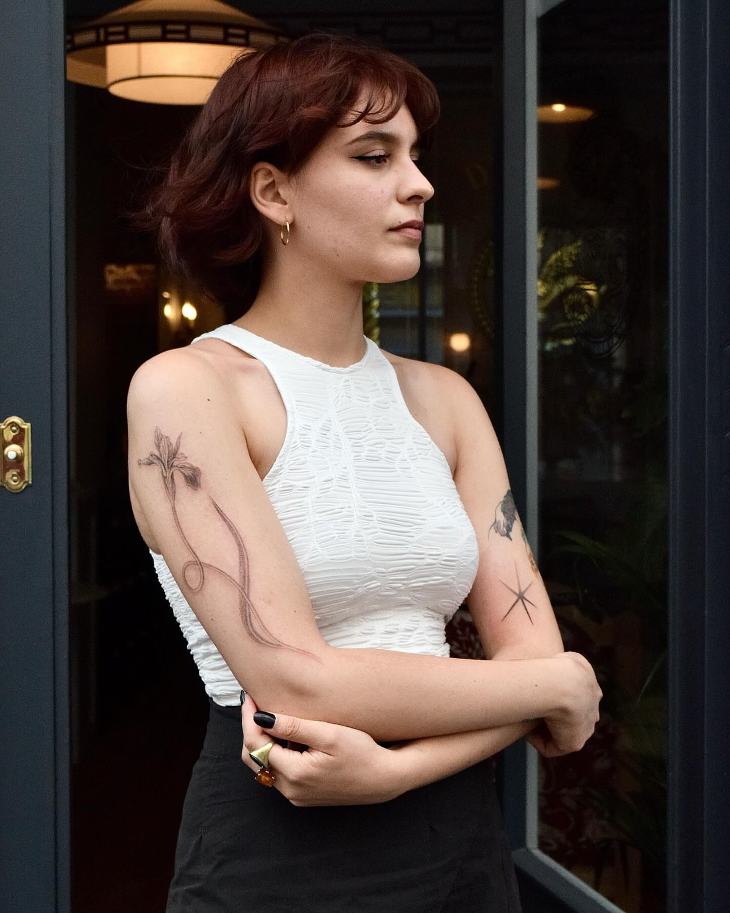Floral design black and grey tattoo on the upper arm by Stella Oh