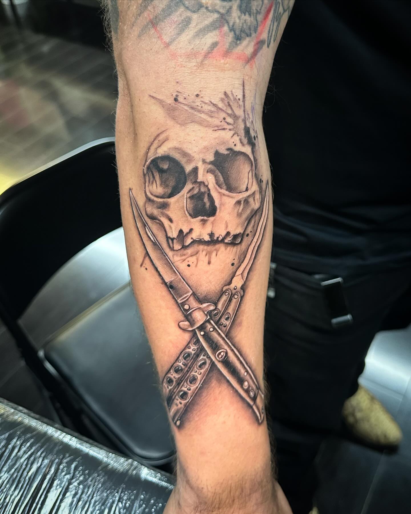 Skull and knives realism tattoo on the forearm by Tattoos by Rey G.