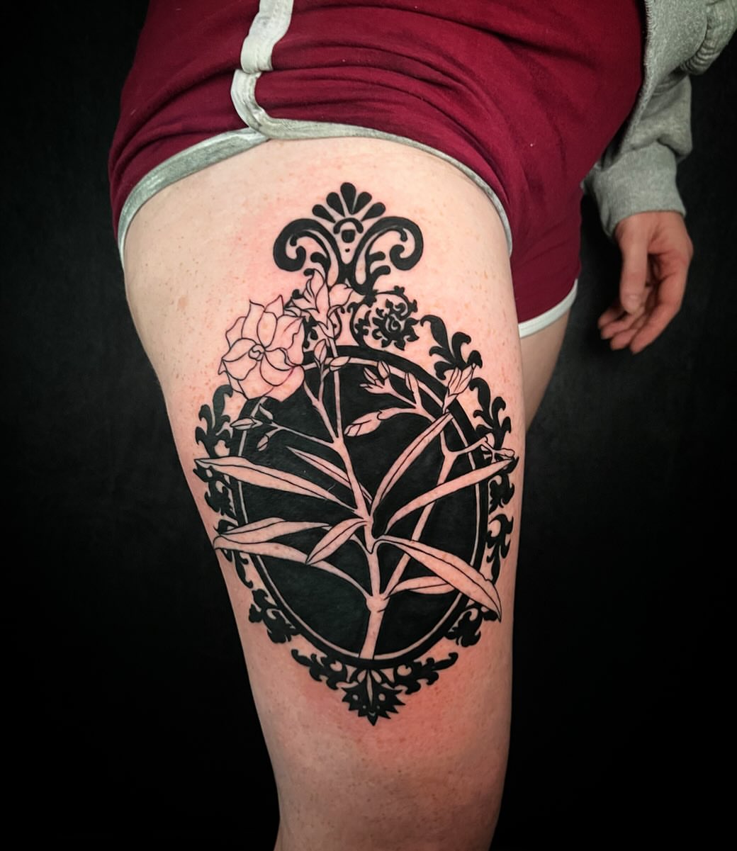 Floral arrangement black and grey tattoo on the thigh by 𝓚𝓪𝓼𝓼𝓪𝓷𝓭𝓻𝓪 𝓜𝓬𝓒𝓪𝓵𝓵, Eugene, Oregon