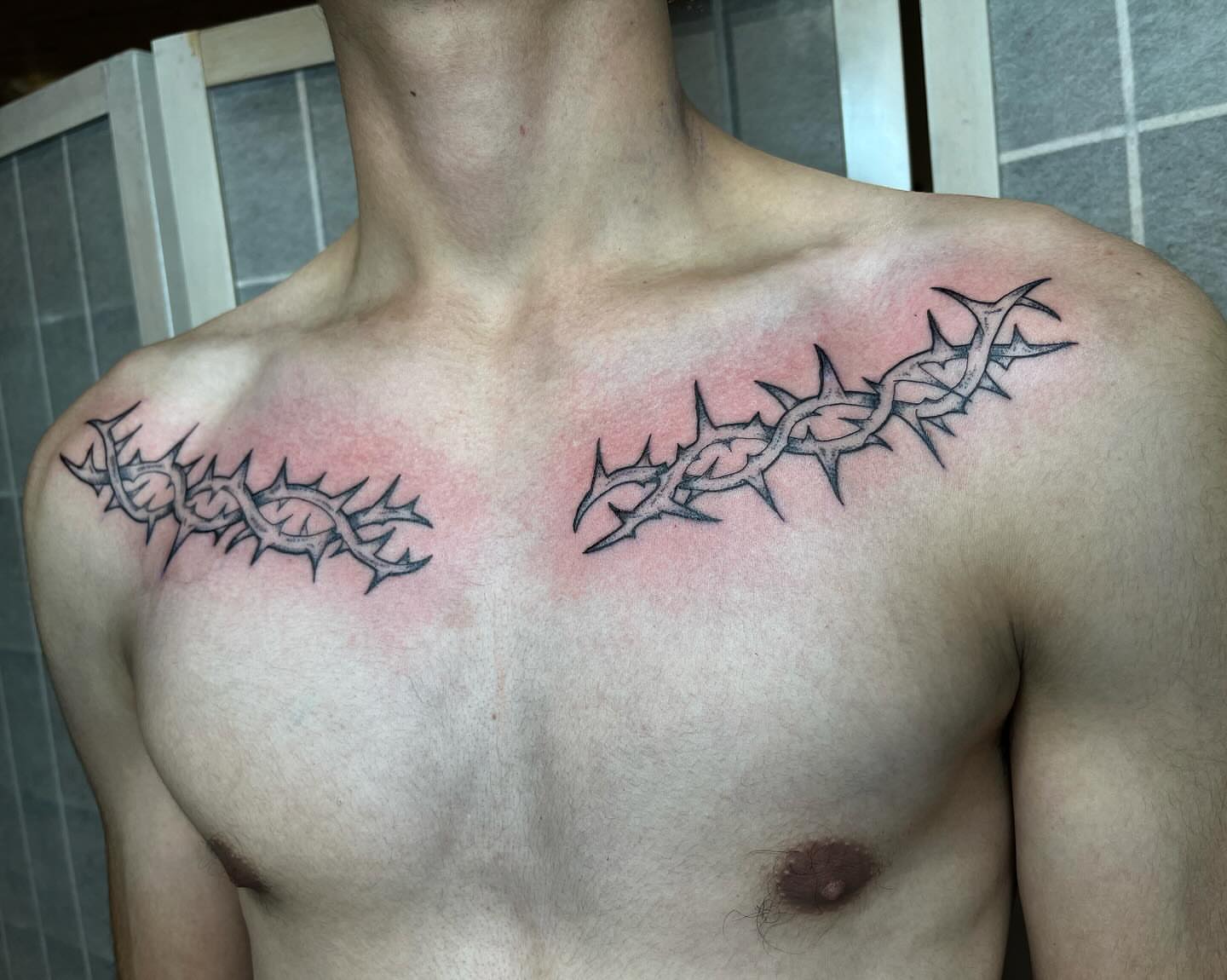 Thorn crown black and grey tattoo on the chest by Taylor Newton