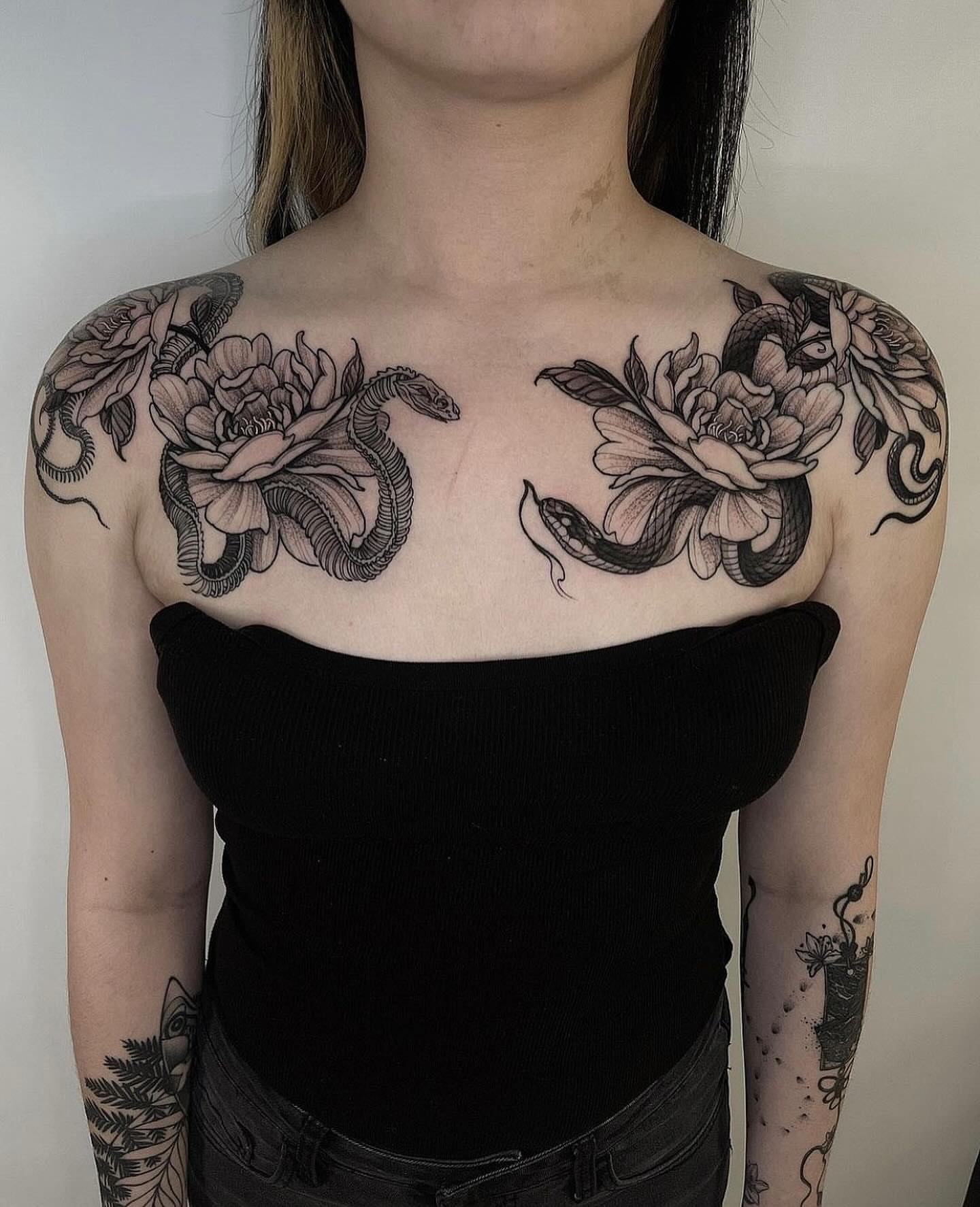 Snake and peony black and grey tattoo on the chest by Las Vegas Tattoo Artist