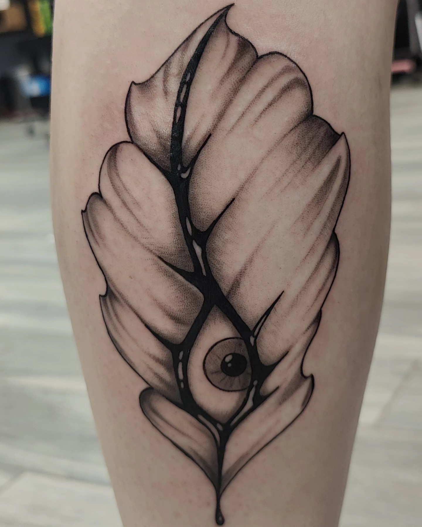 Feather with eye geometric tattoo on the forearm by Ｔｏｍ Ｌｏｒａｎｚ