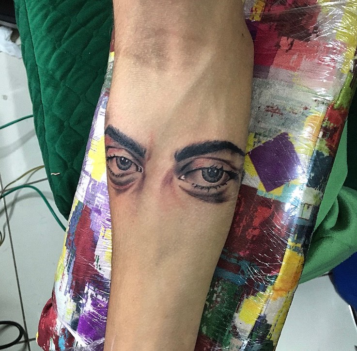 Eyes realism tattoo on the forearm by la flamme