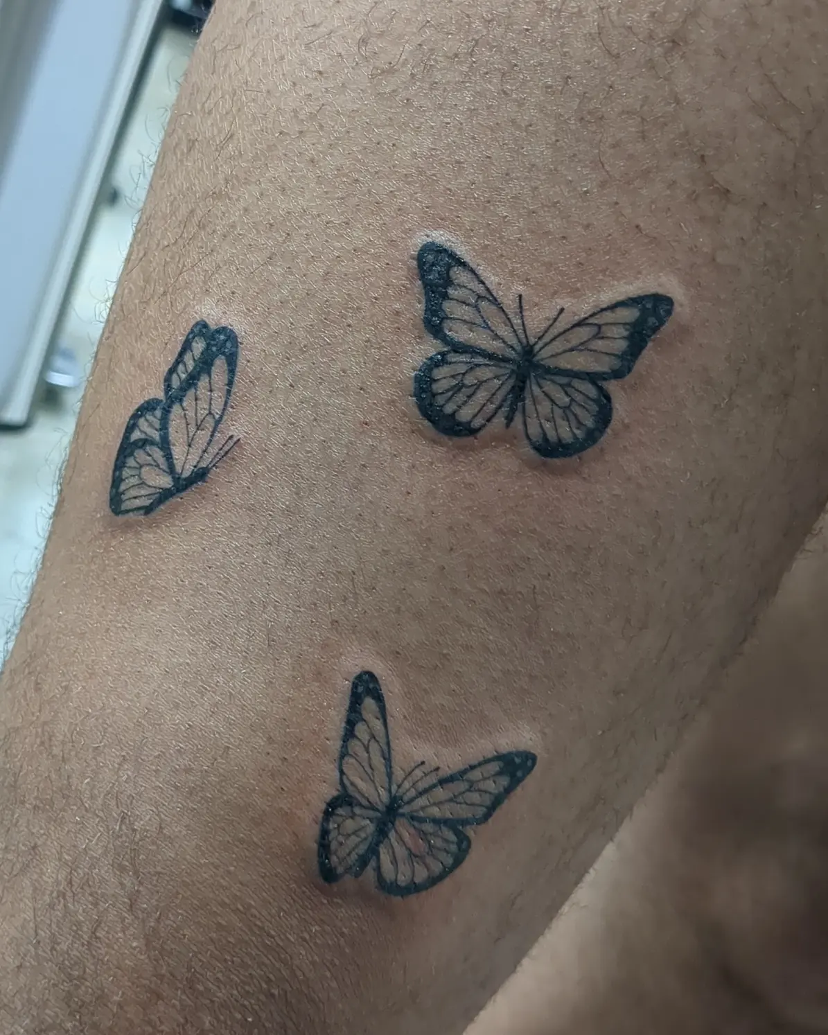 Butterflies black and grey tattoo on the forearm by Seth Chitwood