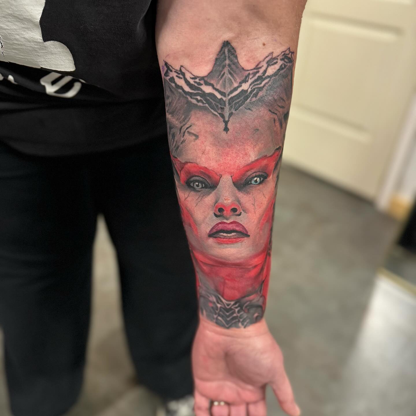 Woman's face realism tattoo on the forearm by Zach Ashton