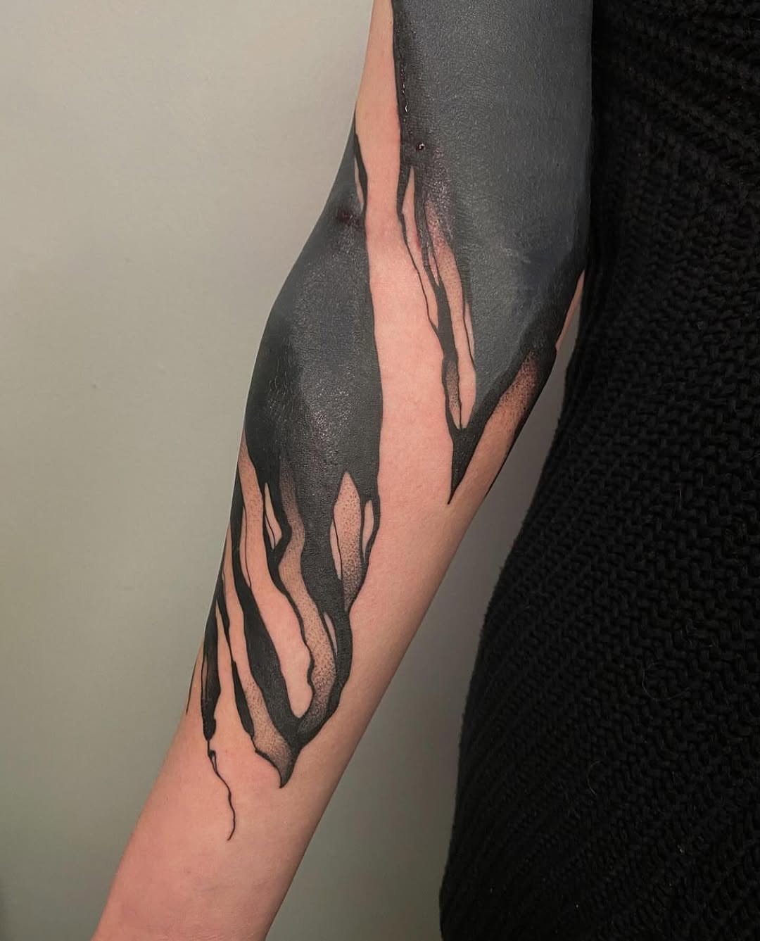 Abstract black ink flow blackwork tattoo on the forearm by Tattoo Artist
