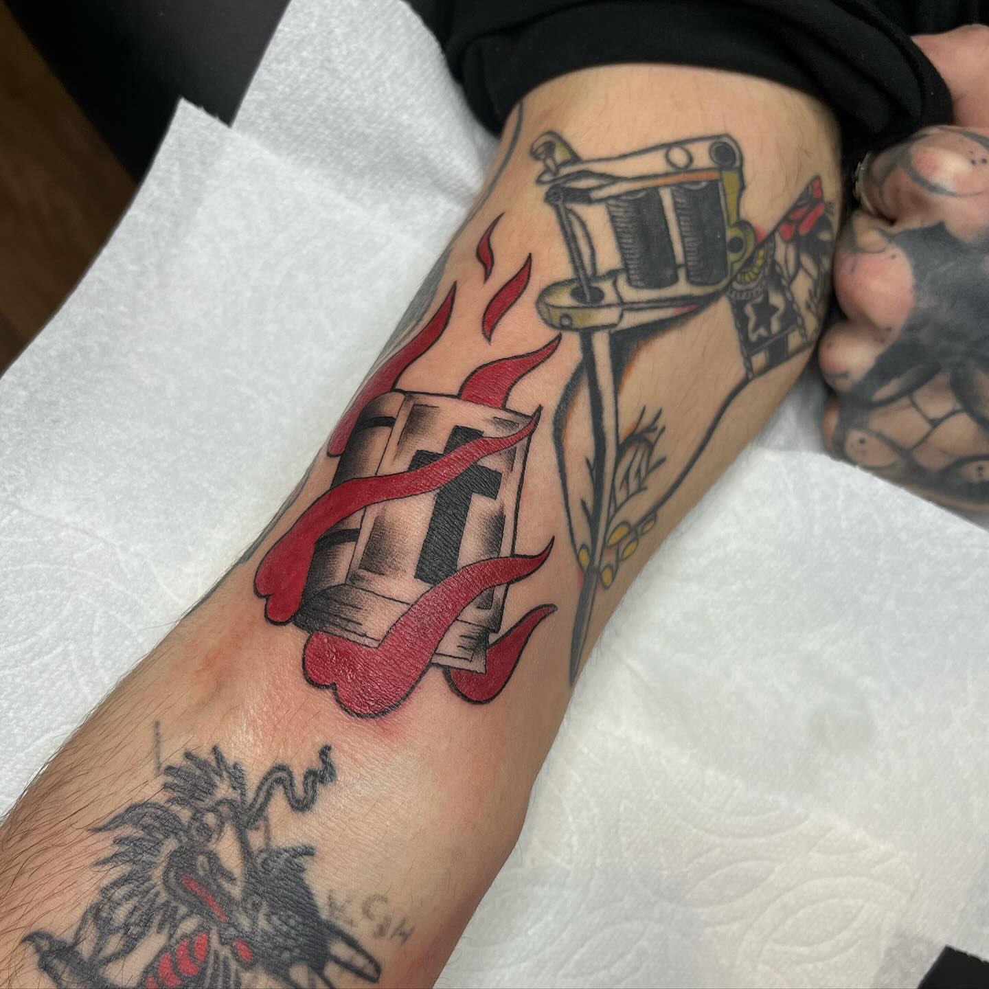 Gun and flames American traditional tattoo on the forearm by Taylor Newton
