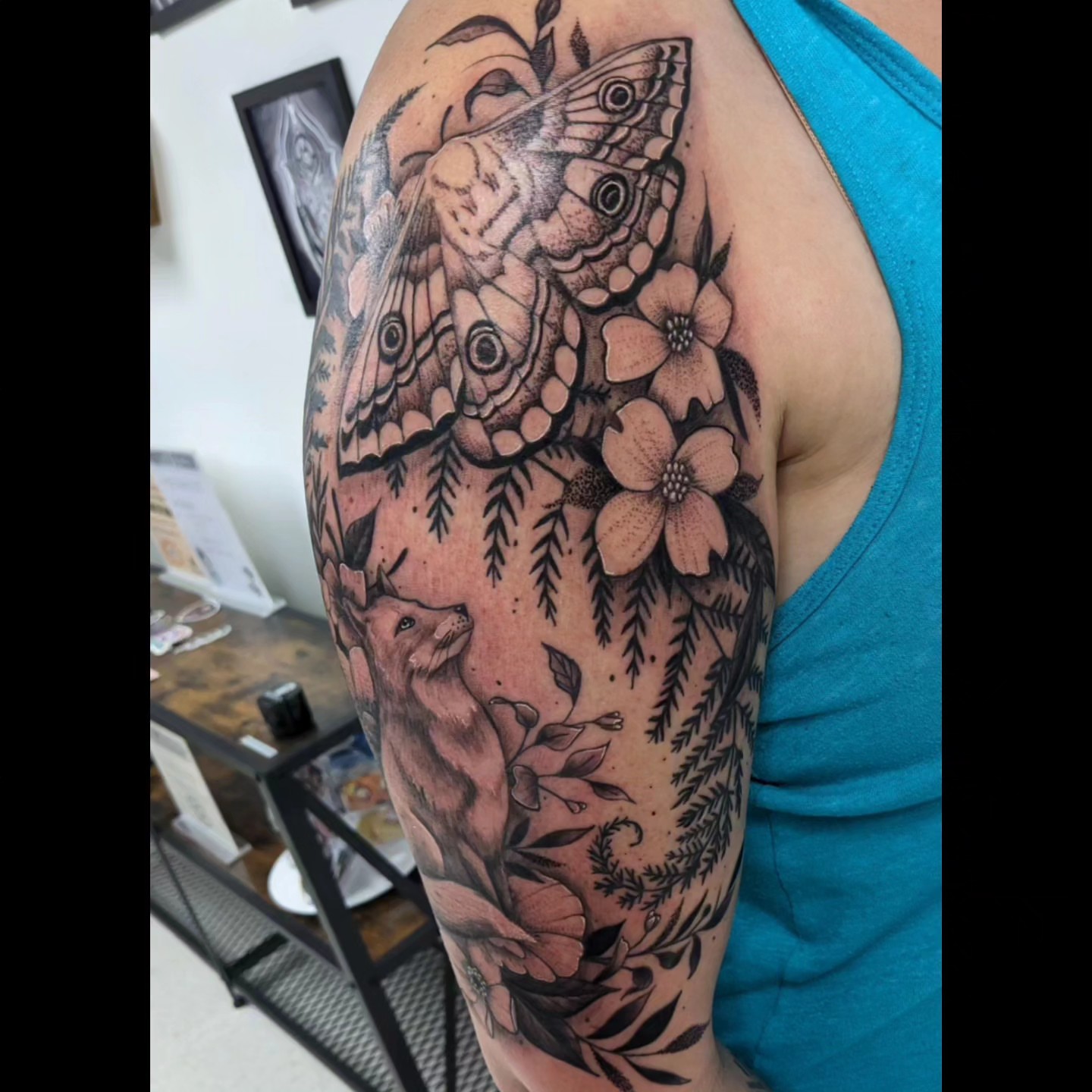 Butterflies and flowers realism tattoo on the upper arm by Ed Gonzalez