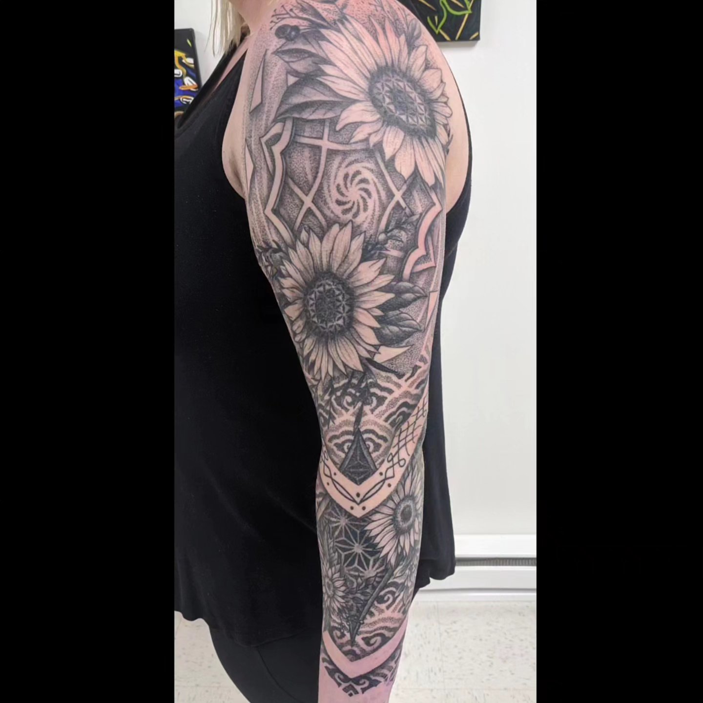 Sunflower dotwork tattoo on the upper arm by Ed Gonzalez