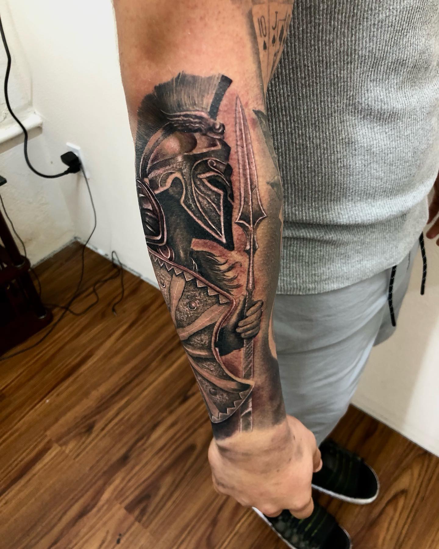 Warrior helmet and sword realism tattoo on the forearm by Kevin Palma
