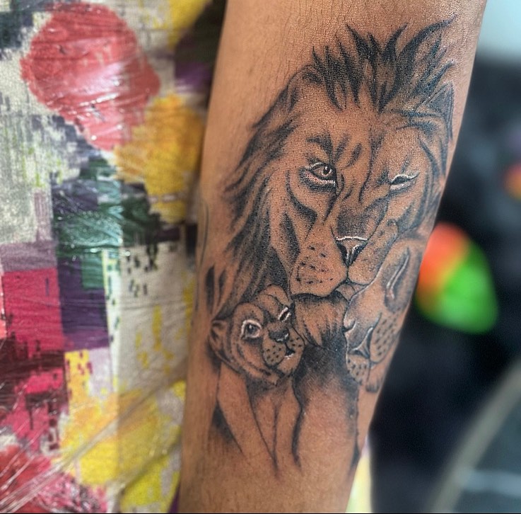 Lion family realism tattoo on the forearm by la flamme