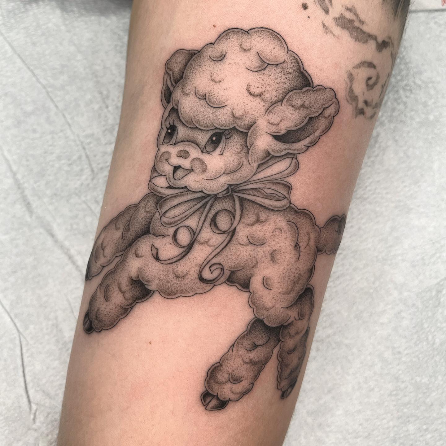 Poodle black and grey tattoo on the forearm by Tiyanna Garlic