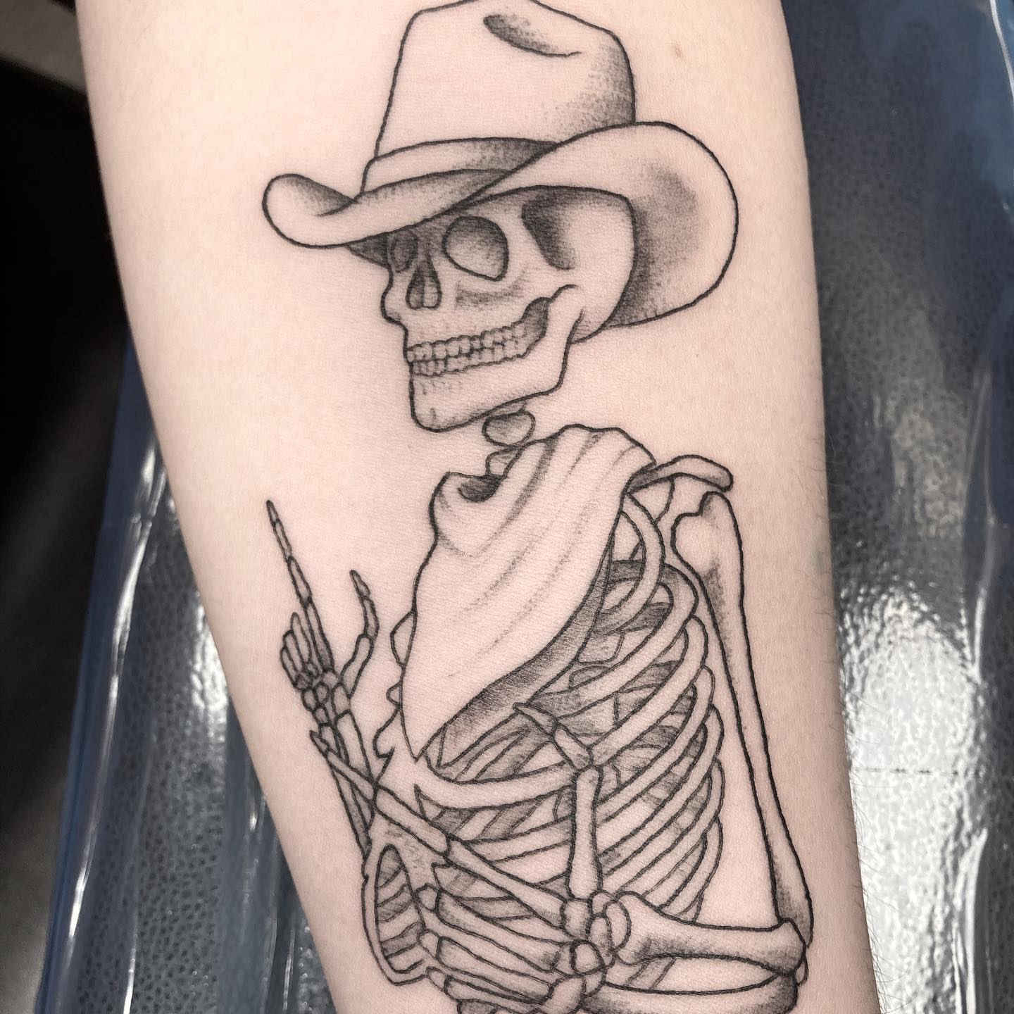 Cowboy skeleton black and grey tattoo on the forearm by Hali Larkin