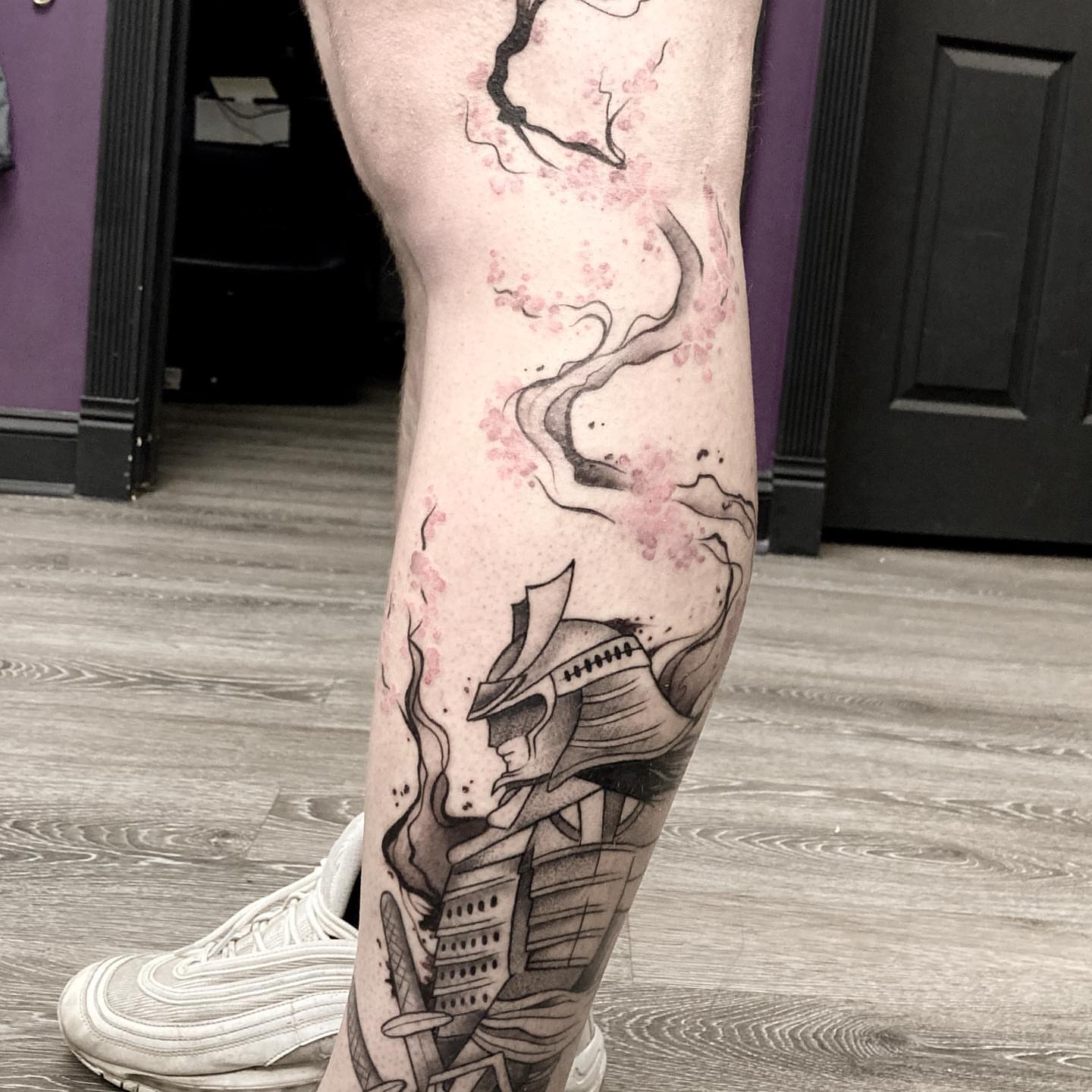 Cherry blossom and samurai helmet realism tattoo on the leg by Hali Larkin