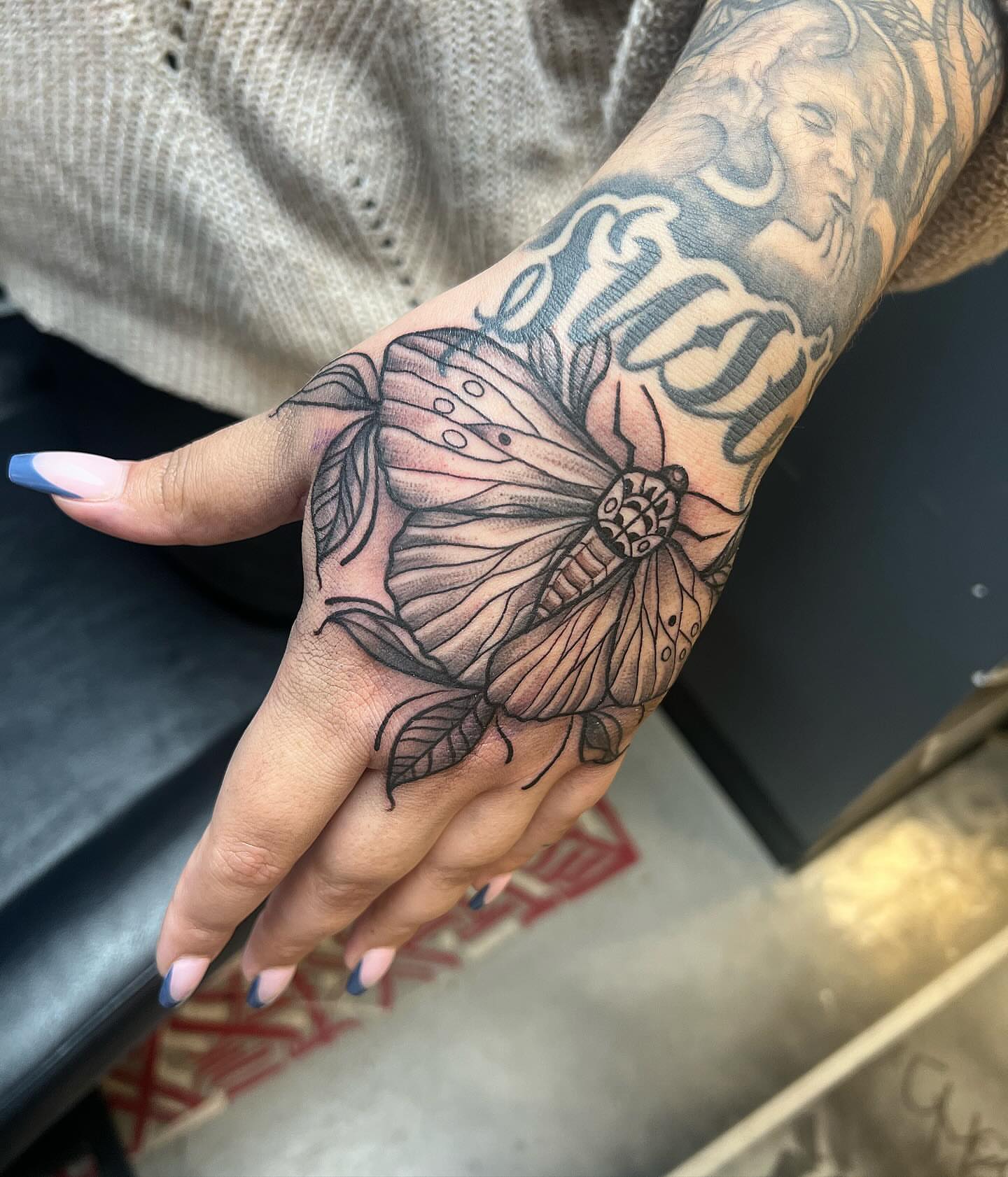 Butterfly black and grey tattoo on the hand by Smuk One