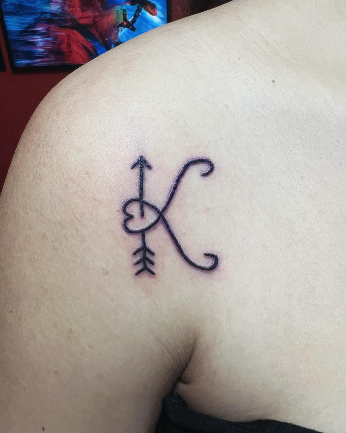 Letter K geometric tattoo on the shoulder by Kai