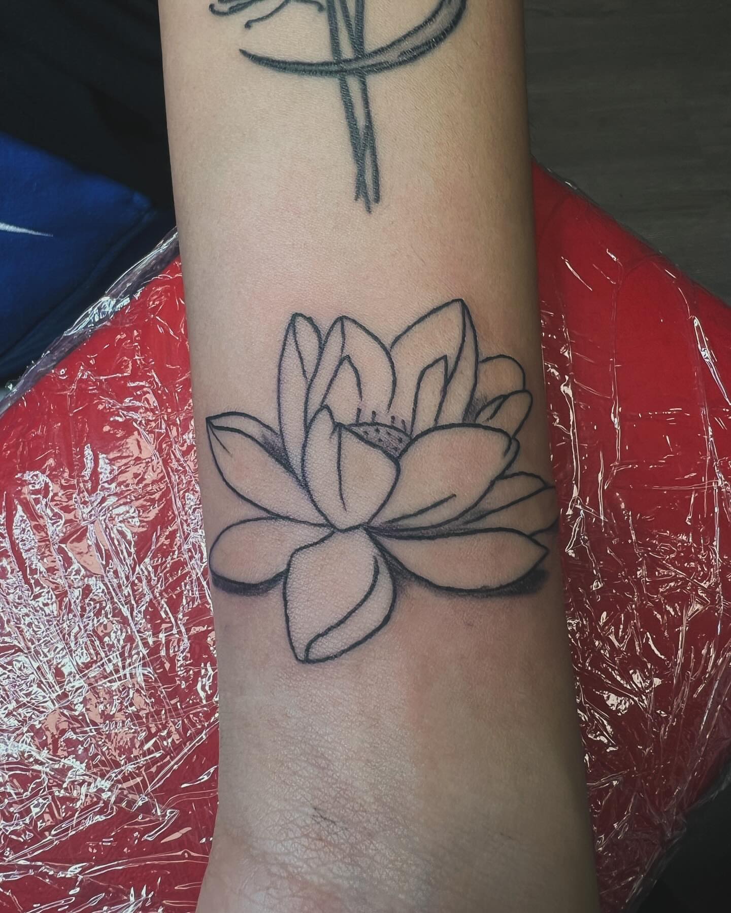 Lotus flower black and grey tattoo on the forearm by Kai