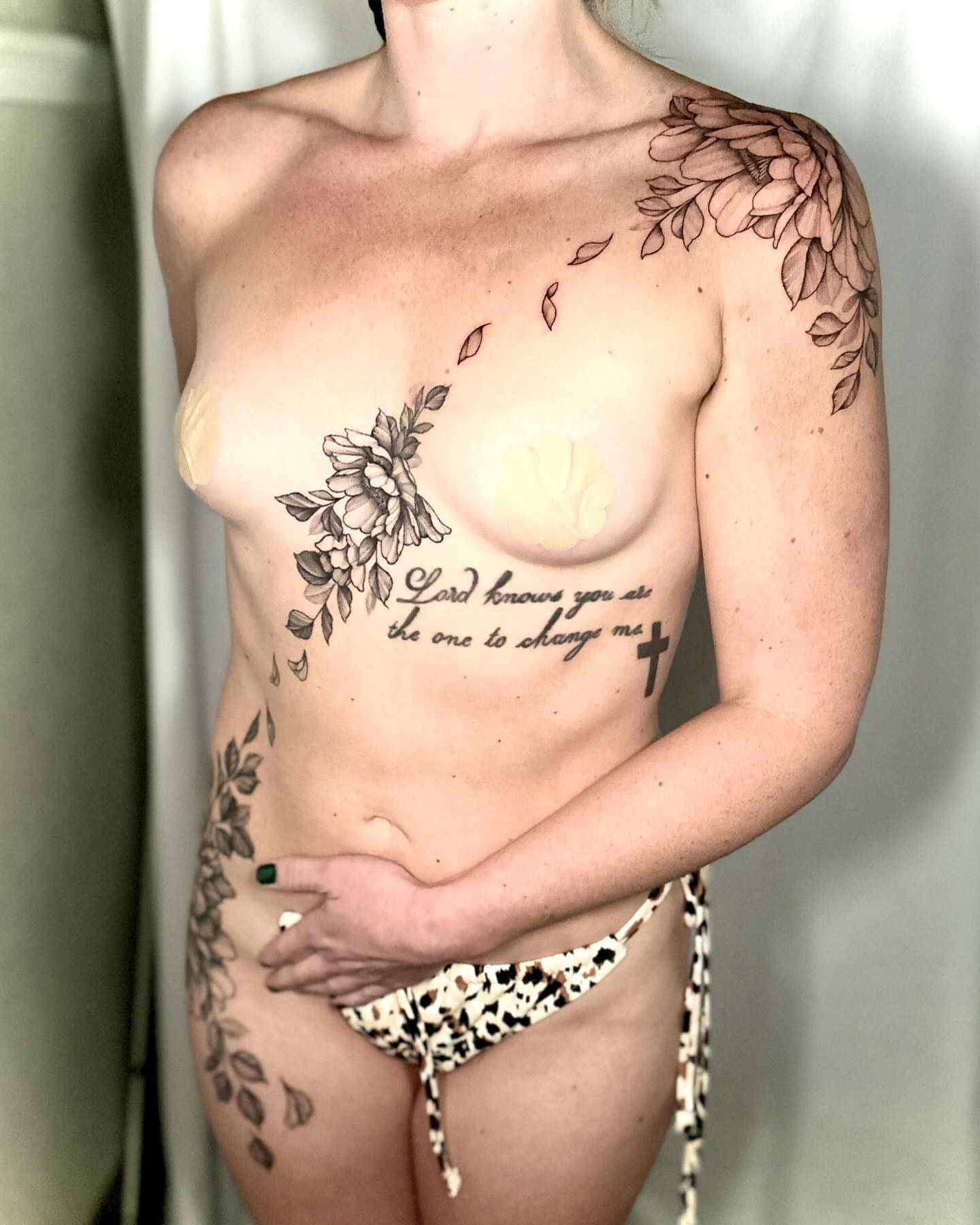 Floral and inspirational text black and grey tattoo on the chest by Stephen Hansen