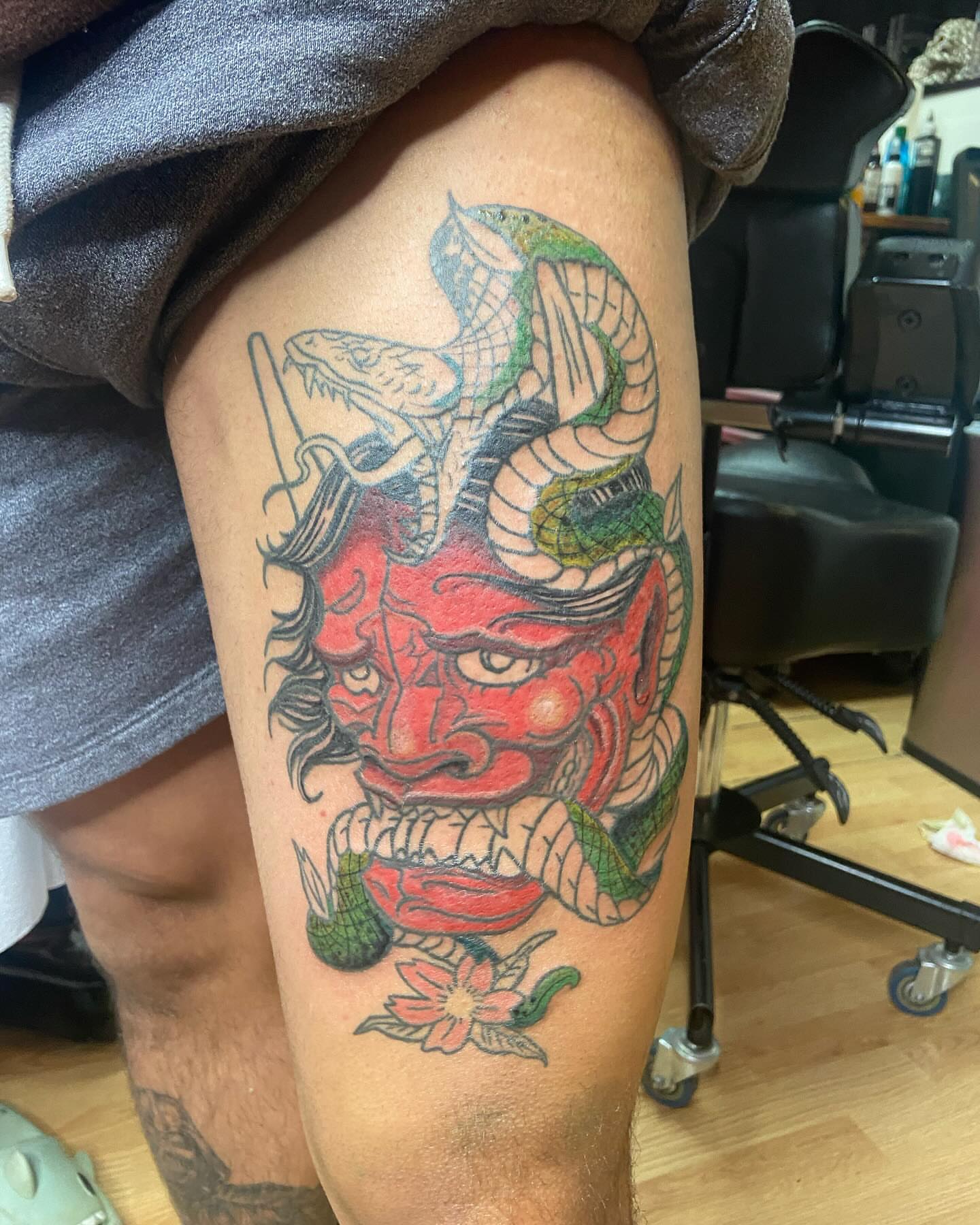 Demon mask American traditional tattoo on the thigh by Ride The Needle Tattoos, New Britain, Connecticut